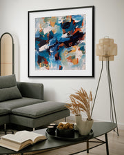 Living room with a gray sectional sofa, coffee table, and abstract art on the wall.