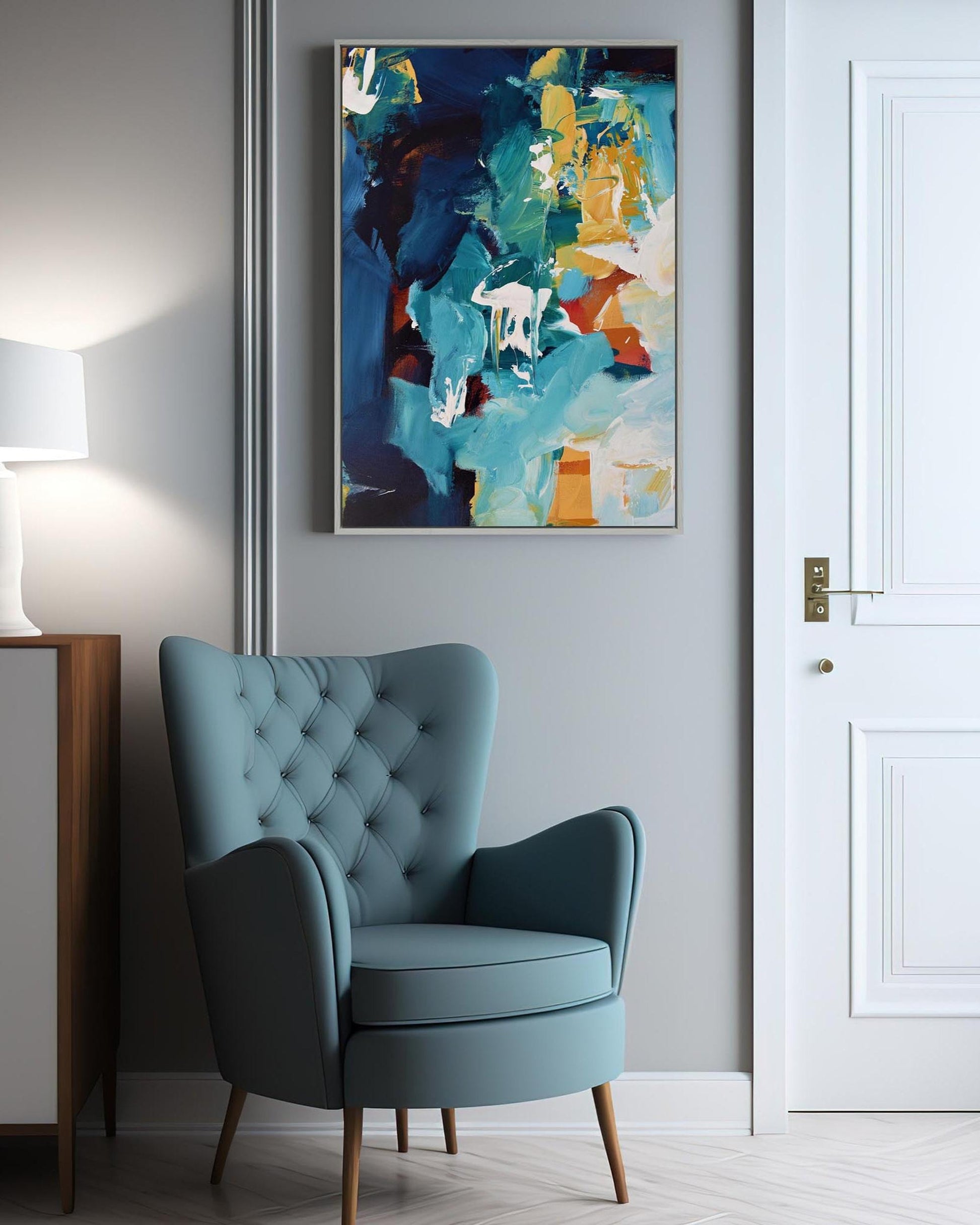 Blue armchair in a room with a colorful abstract painting on the wall.