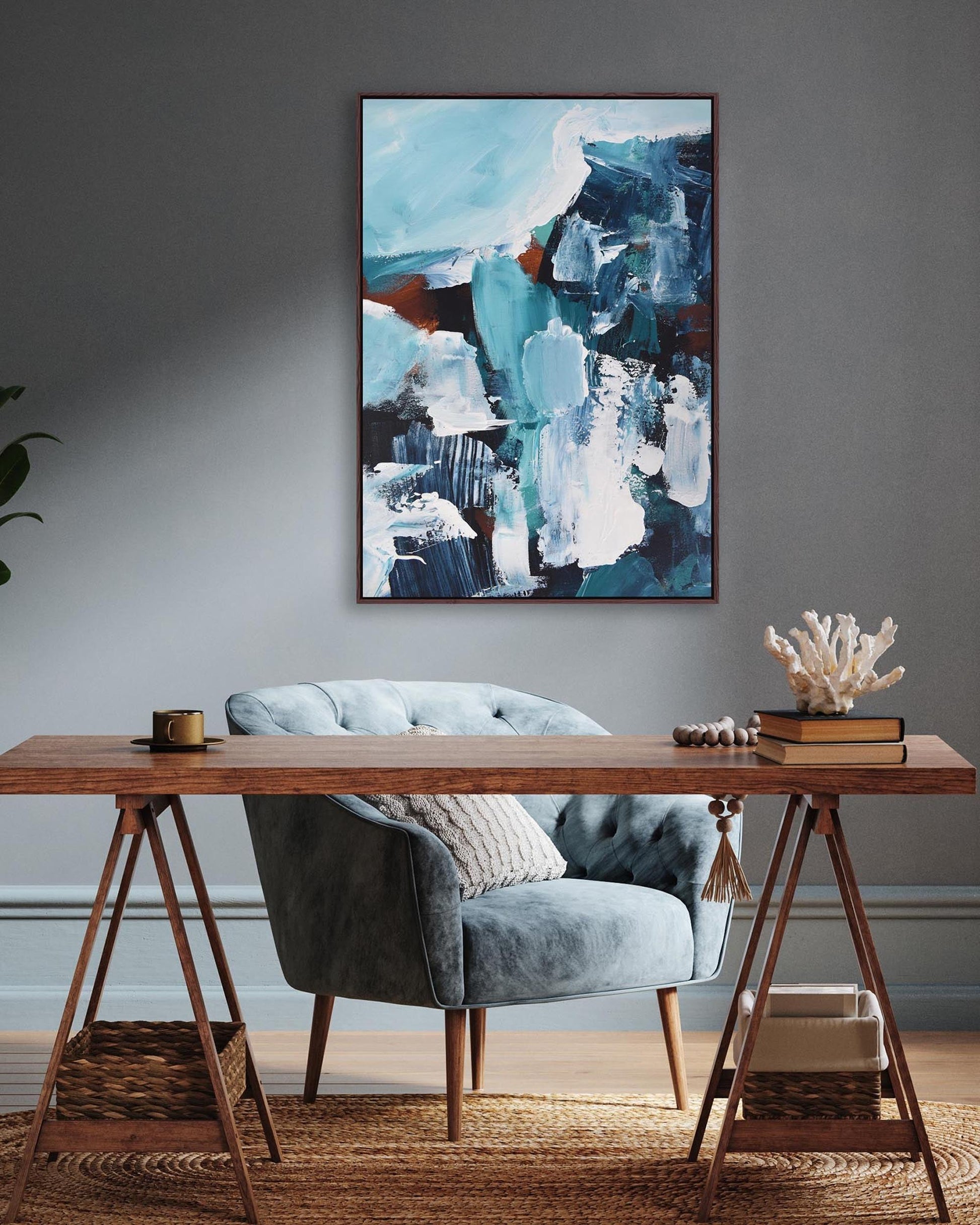 Modern interior with a wooden desk, gray chair, and abstract painting on a gray wall.
