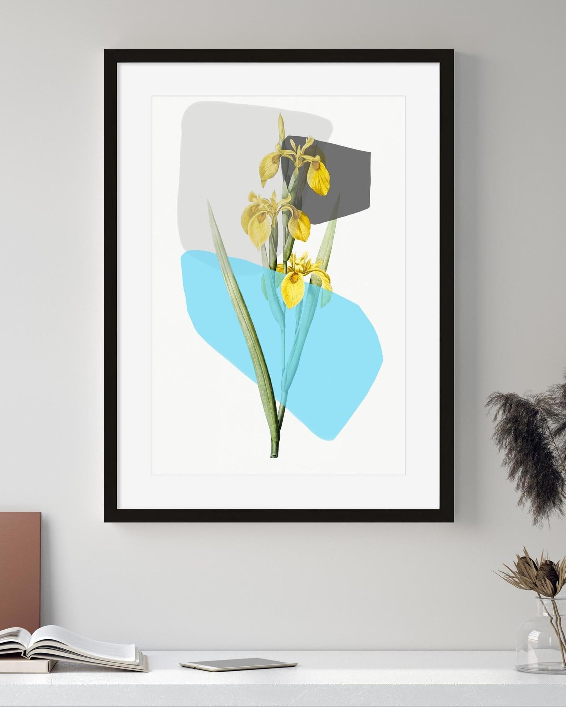 Framed artwork of yellow flowers on a white wall with minimal decor.