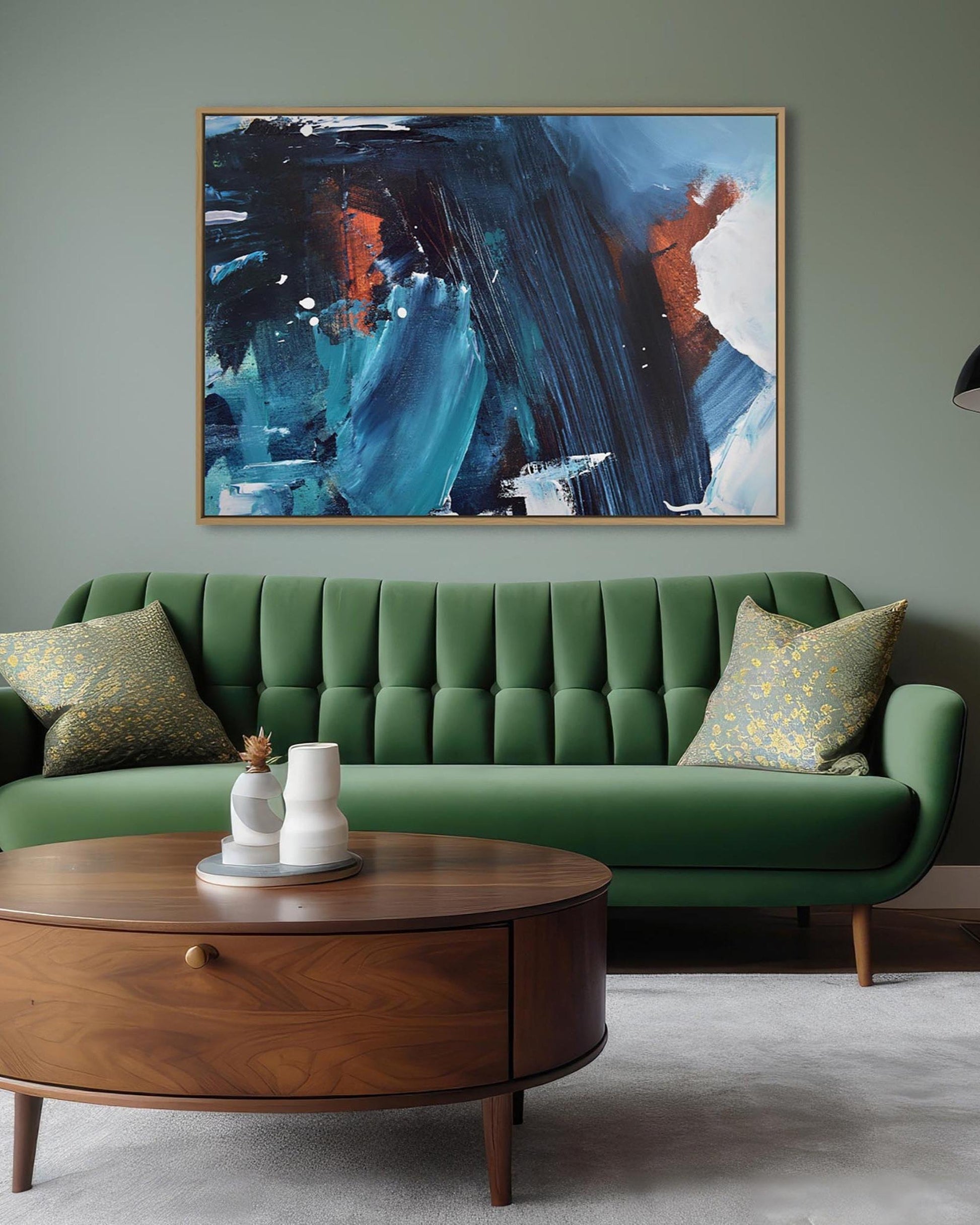 Green sofa with a wooden coffee table and abstract painting in a living room.