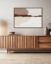 Wooden sideboard in a modern living room with abstract art and decor.