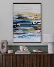 Abstract painting on a wall above a wooden console table with decorative items.