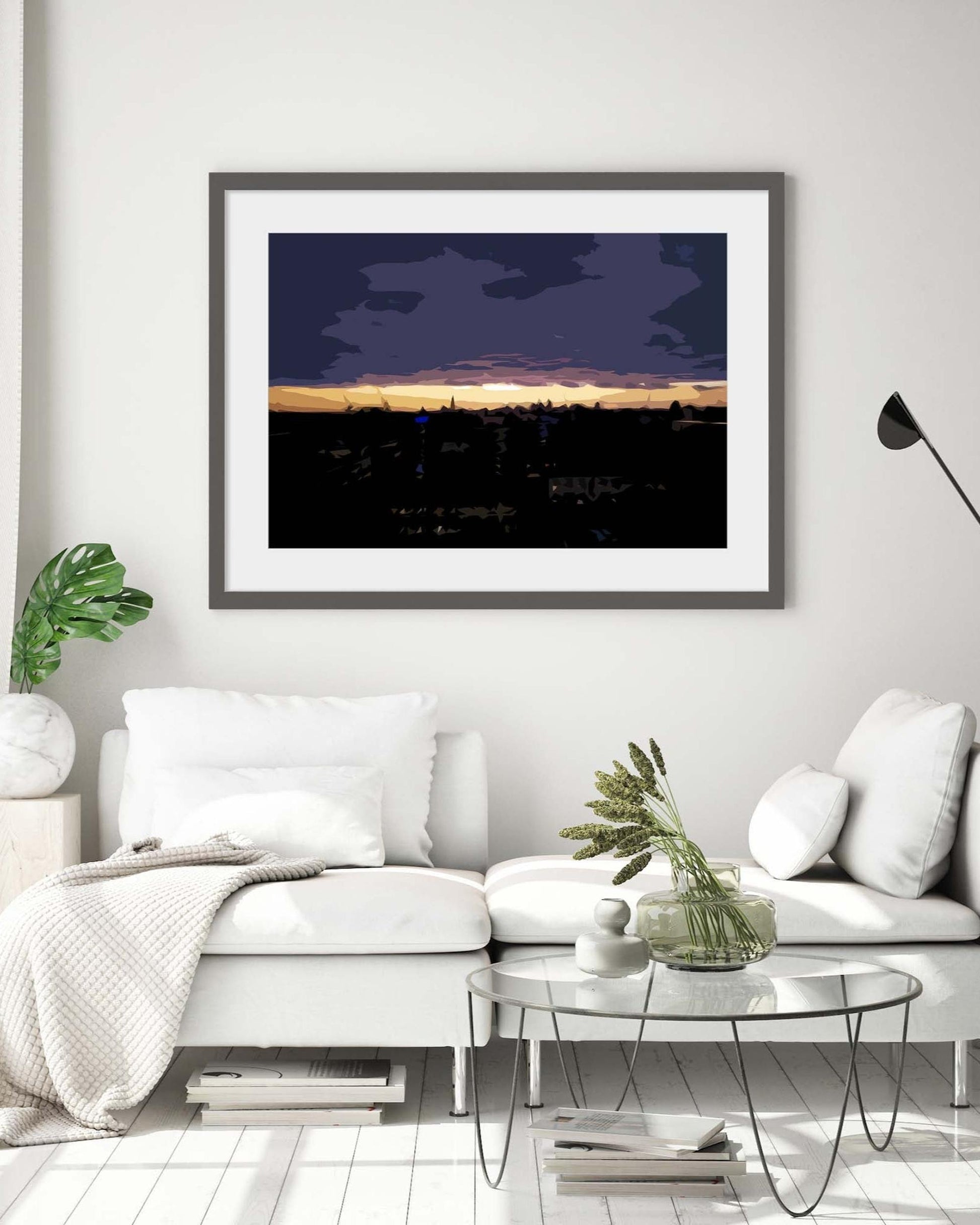 Framed artwork above a white sofa in a living room