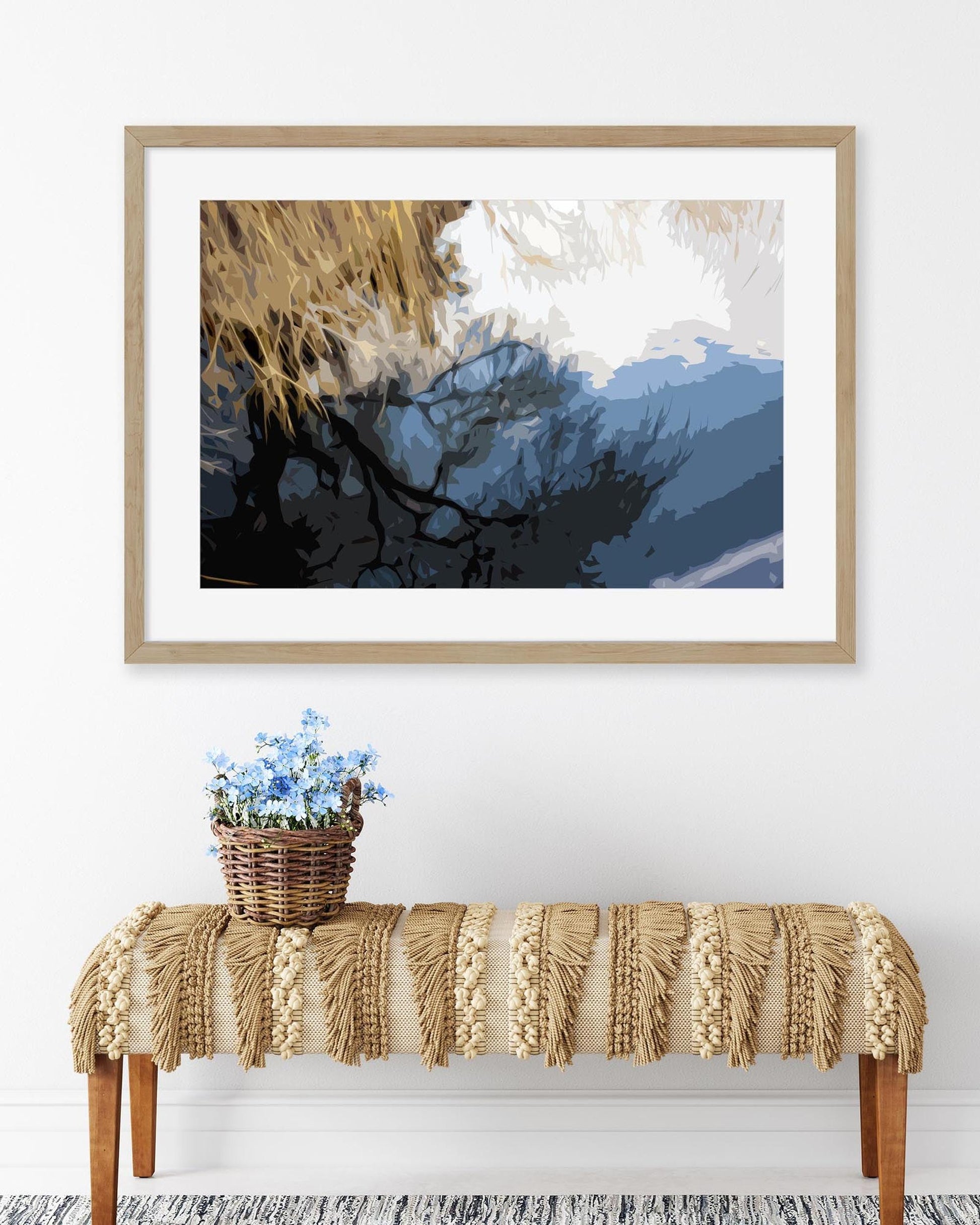 Framed artwork above a console table with decorative elements