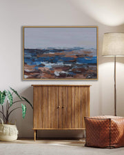 Room interior with abstract painting, wooden cabinet, lamp, and plant.