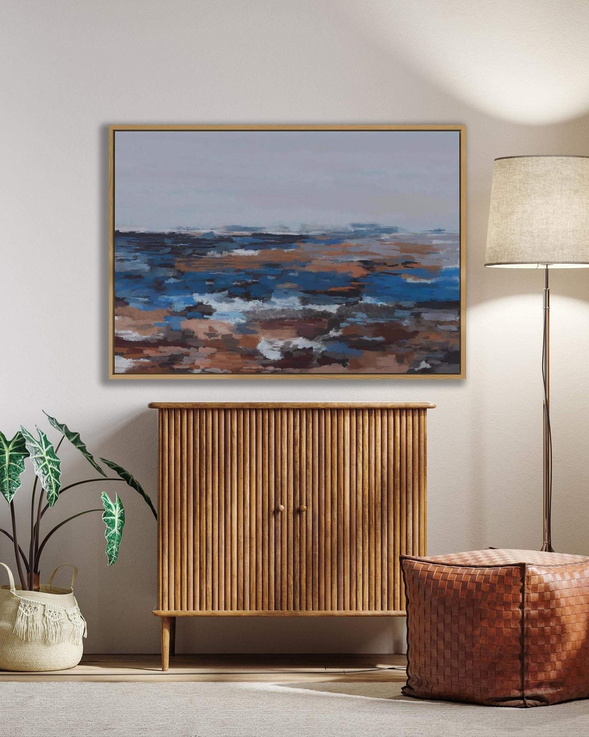 Room interior with abstract painting, wooden cabinet, lamp, and plant.