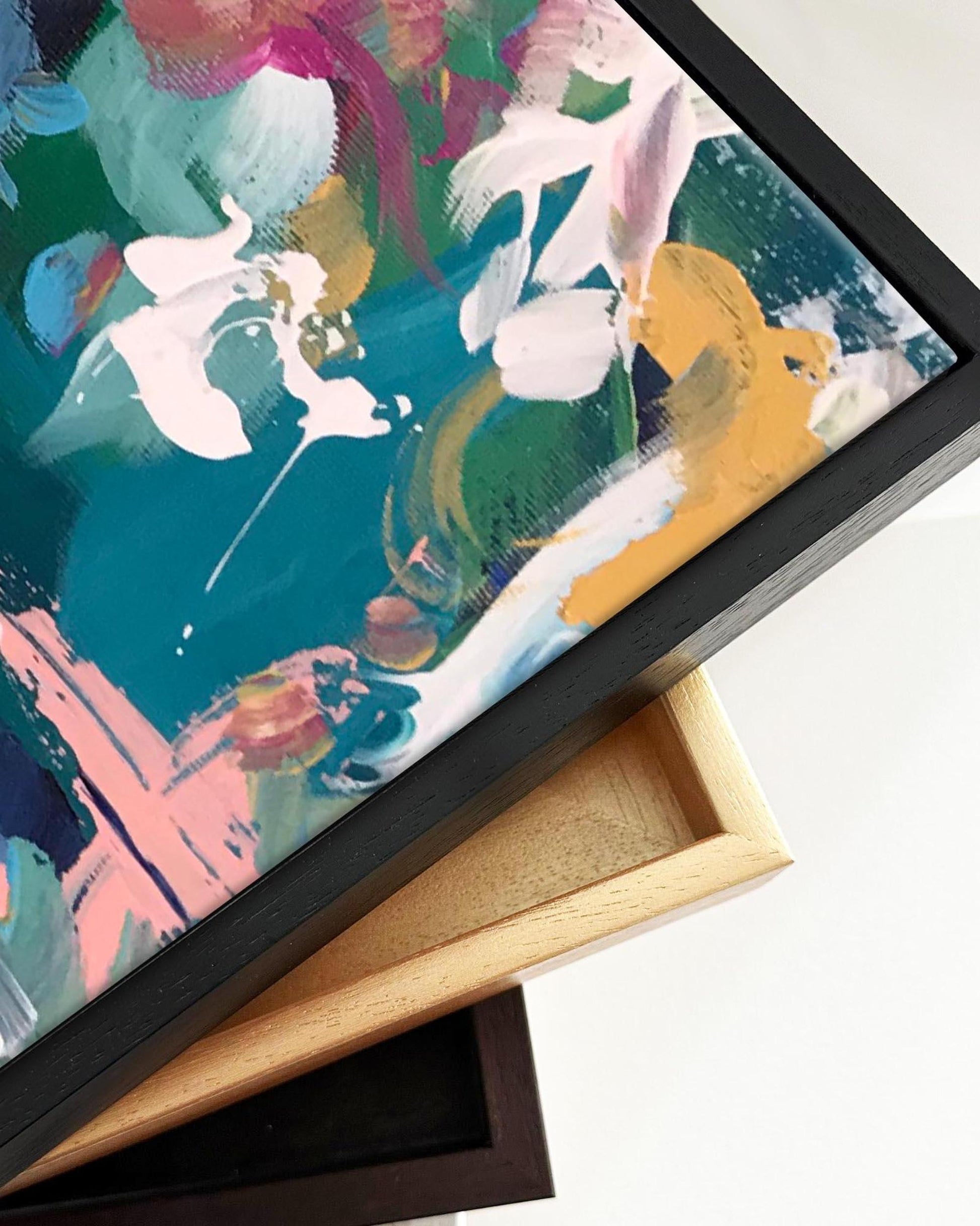 Colorful abstract painting in a black frame on a white background