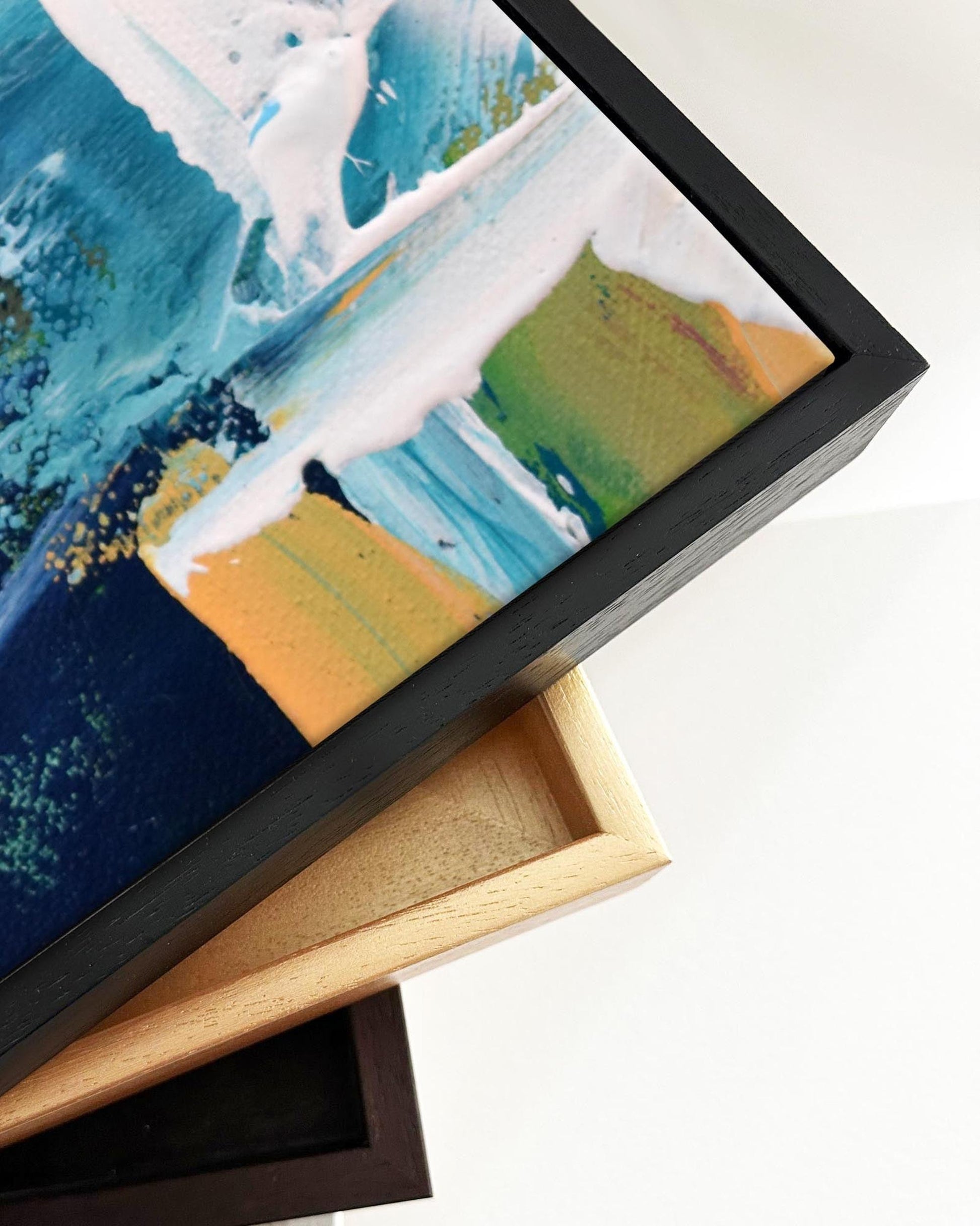 Framed abstract artwork with a black frame on a white background