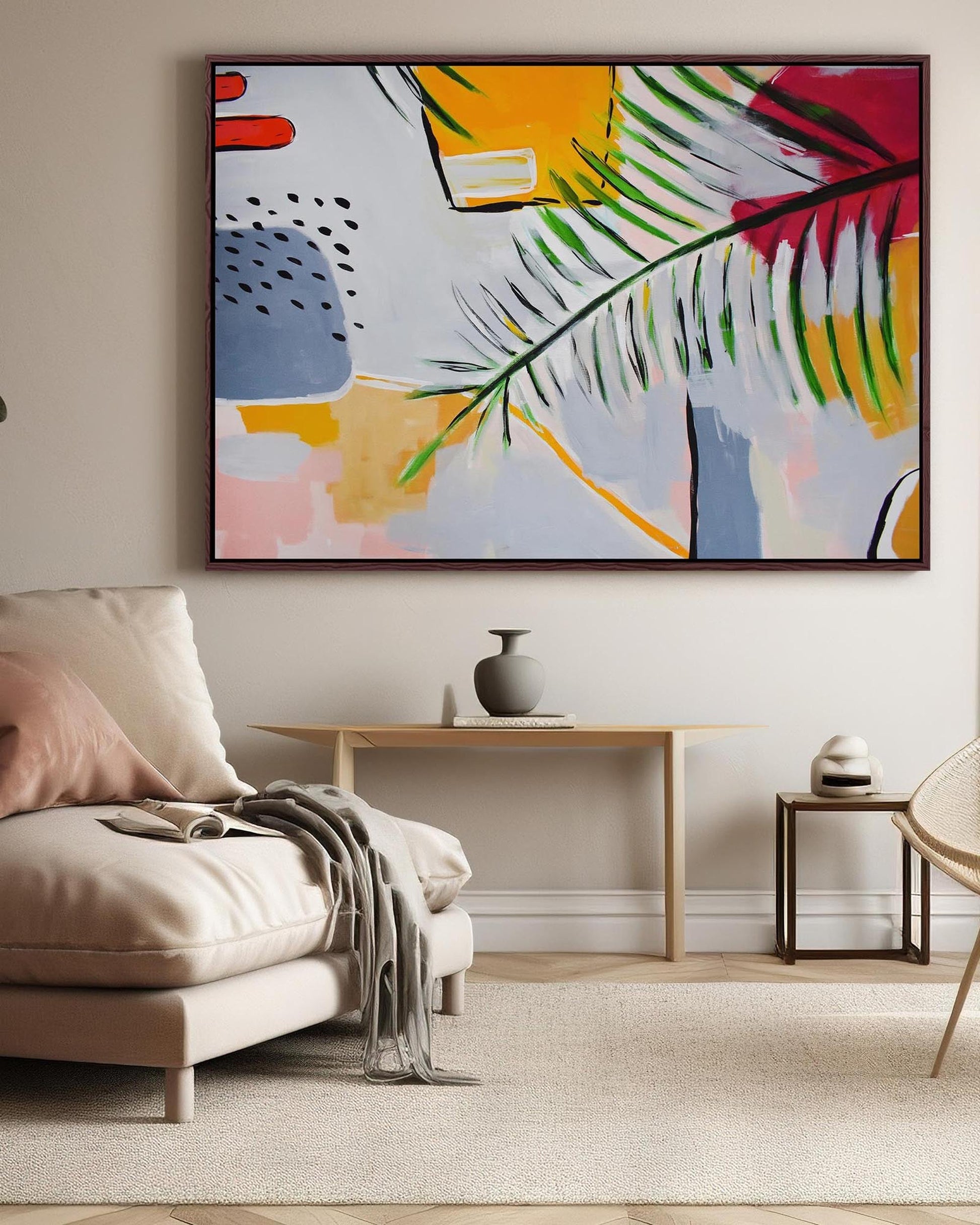 Living room with a beige sofa, abstract painting on the wall, and a small table with decor items.