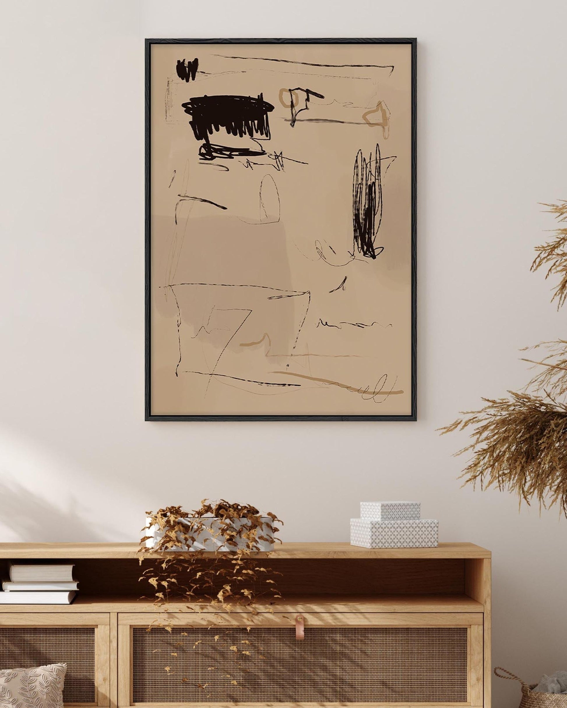 Abstract artwork on a beige wall above a wooden console table.