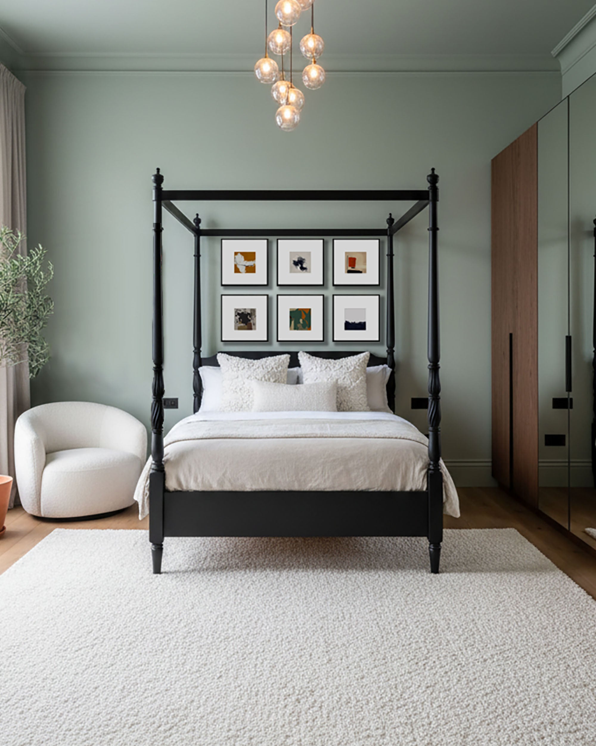 modern bedroom wall art, gallery wall of 6 pictures on wall, four poster bed with large bubble chandelier lights and mirrored four piece wardrobe and olive tree