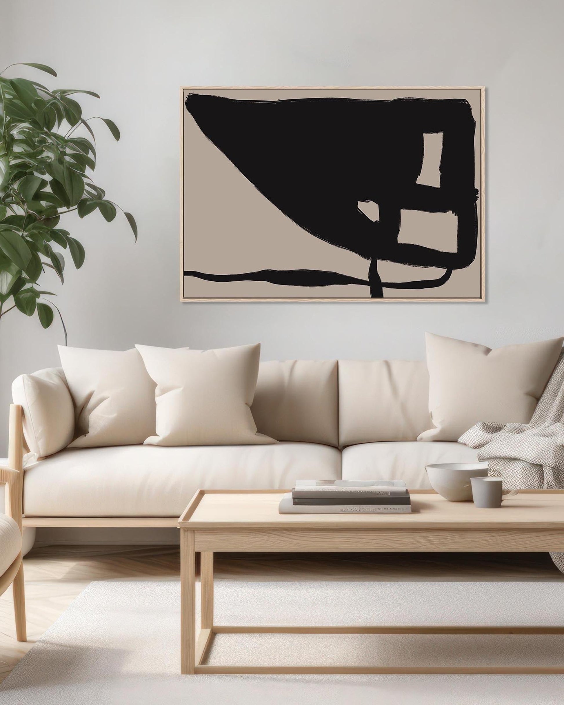 Modern living room with a beige sofa, wooden coffee table, and abstract art on the wall.