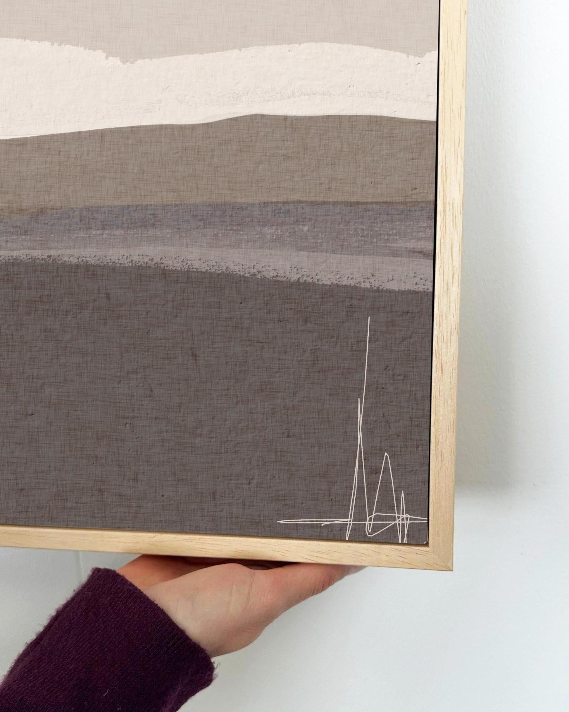 Framed abstract artwork with a minimalistic design on a plain background