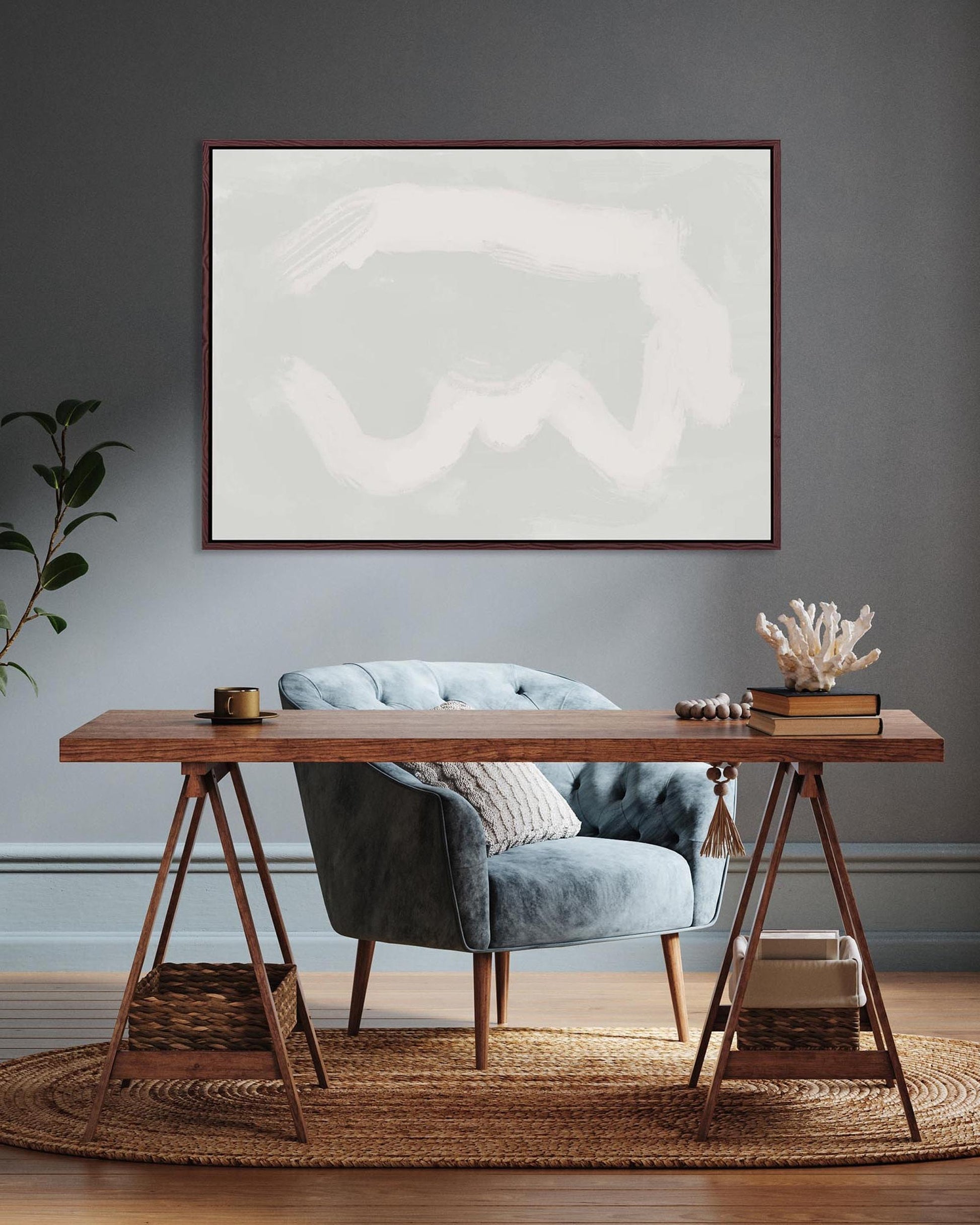 Modern interior with a wooden desk, gray chair, and abstract artwork on a gray wall.
