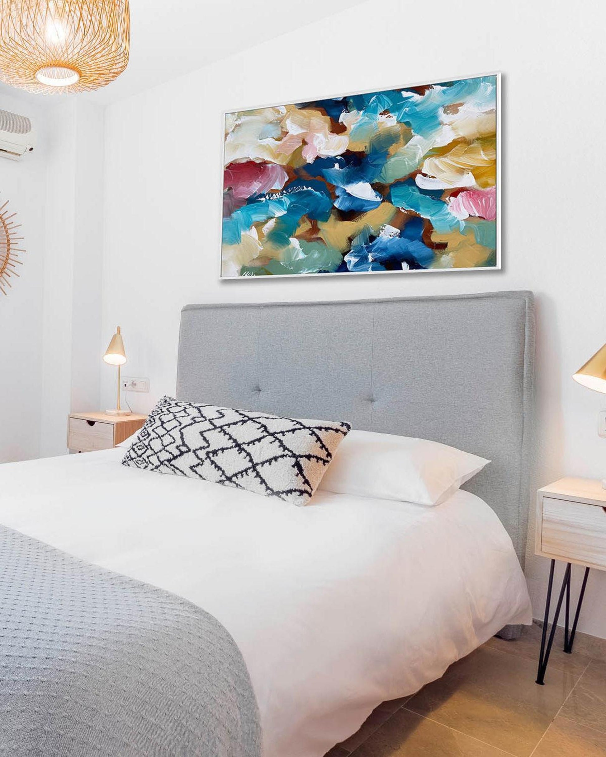 Bedroom with a colorful abstract painting above the bed