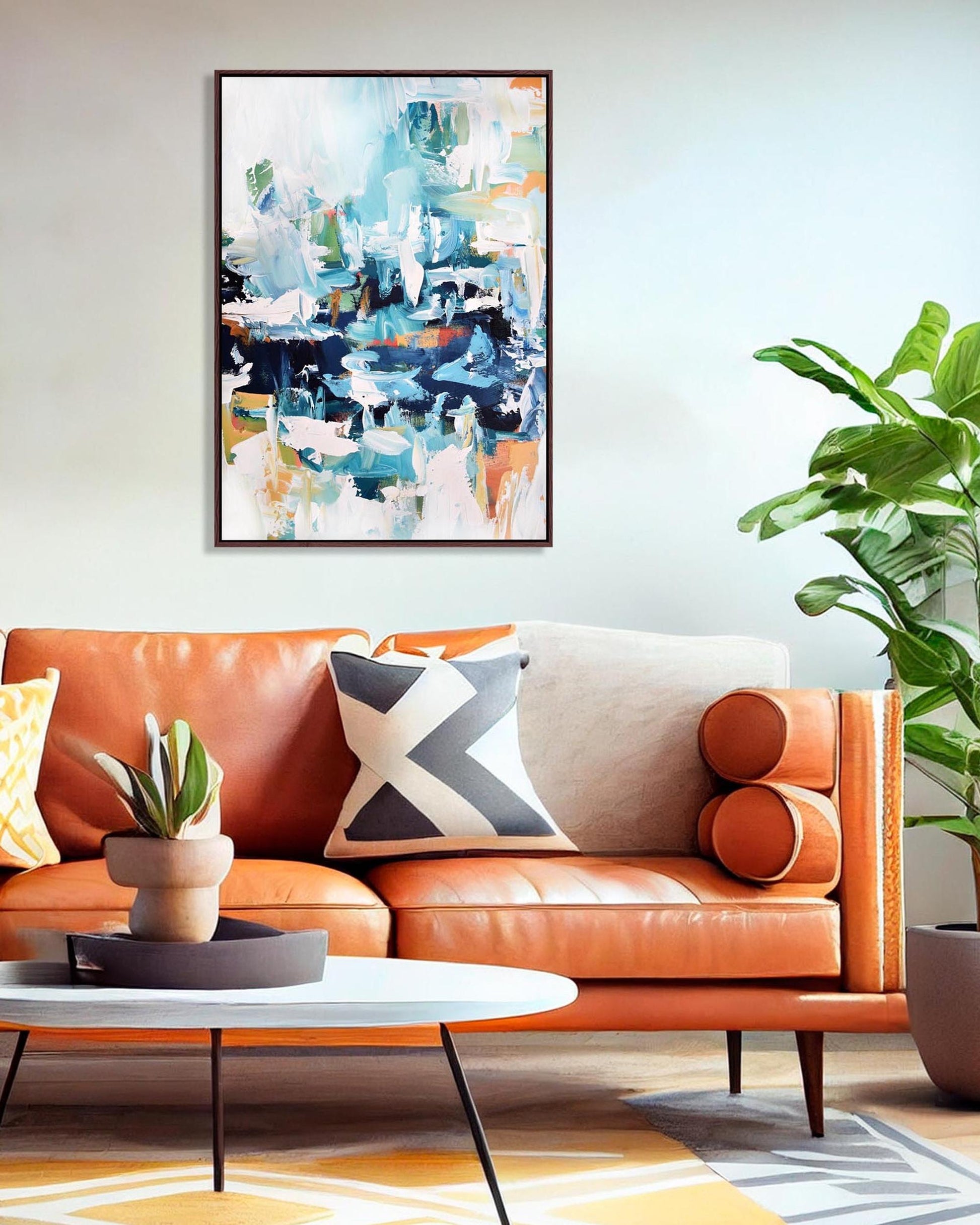 Living room with orange sofa, abstract art, and plants