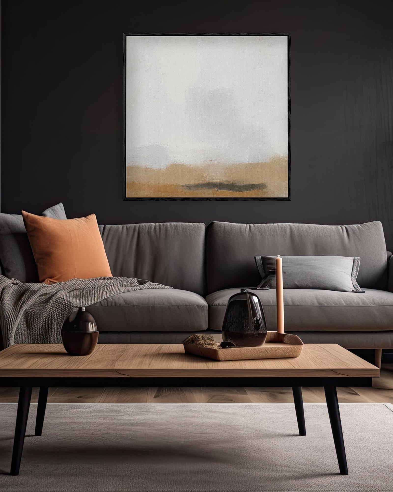 Modern living room with a gray sofa, wooden coffee table, and abstract art on the wall.