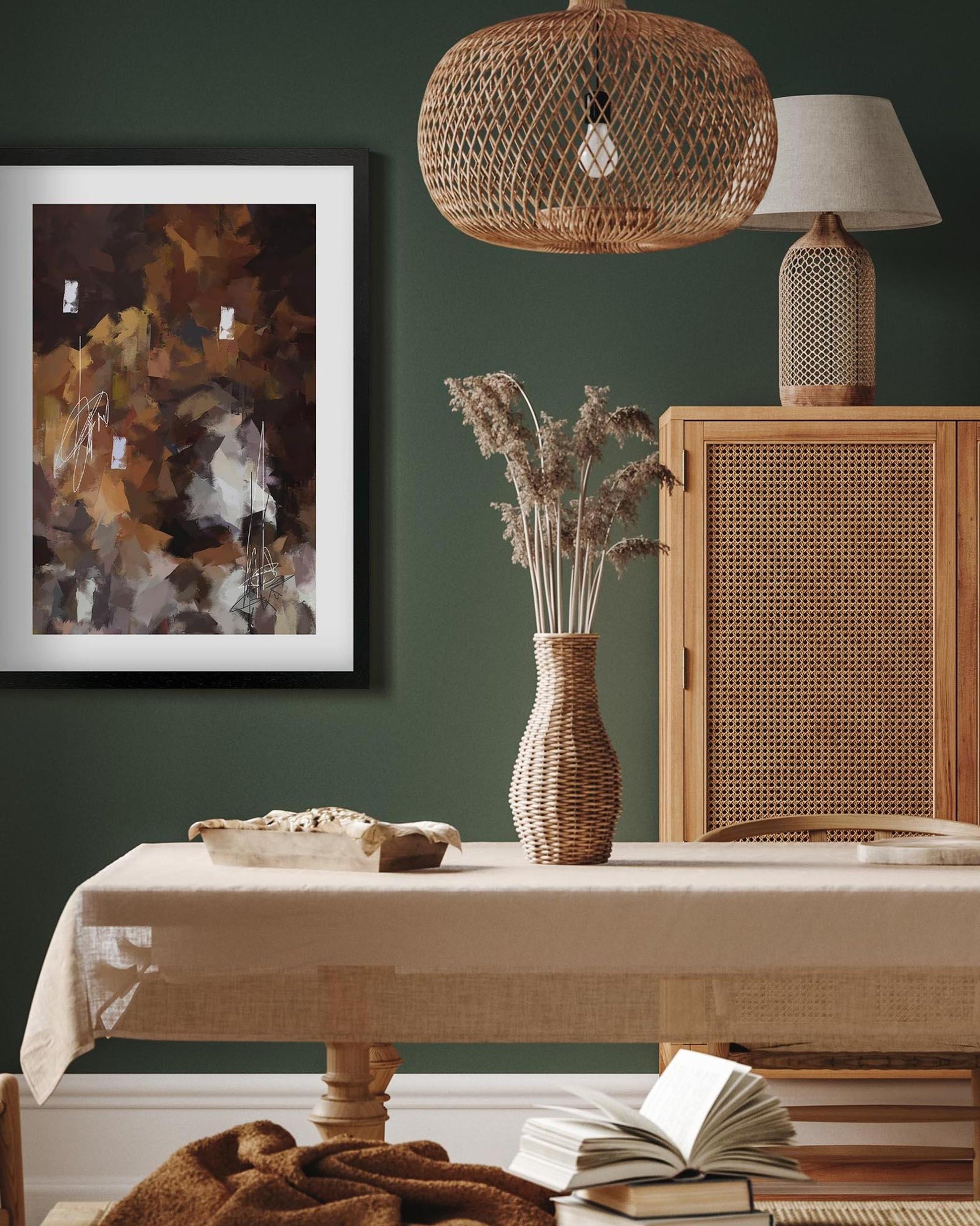 Nest living room with wicker furniture, abstract art, and decorative items against a green wall.