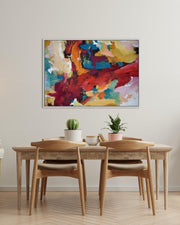 Dining room with a wooden table and chairs, plants, and a colorful abstract painting on the wall.