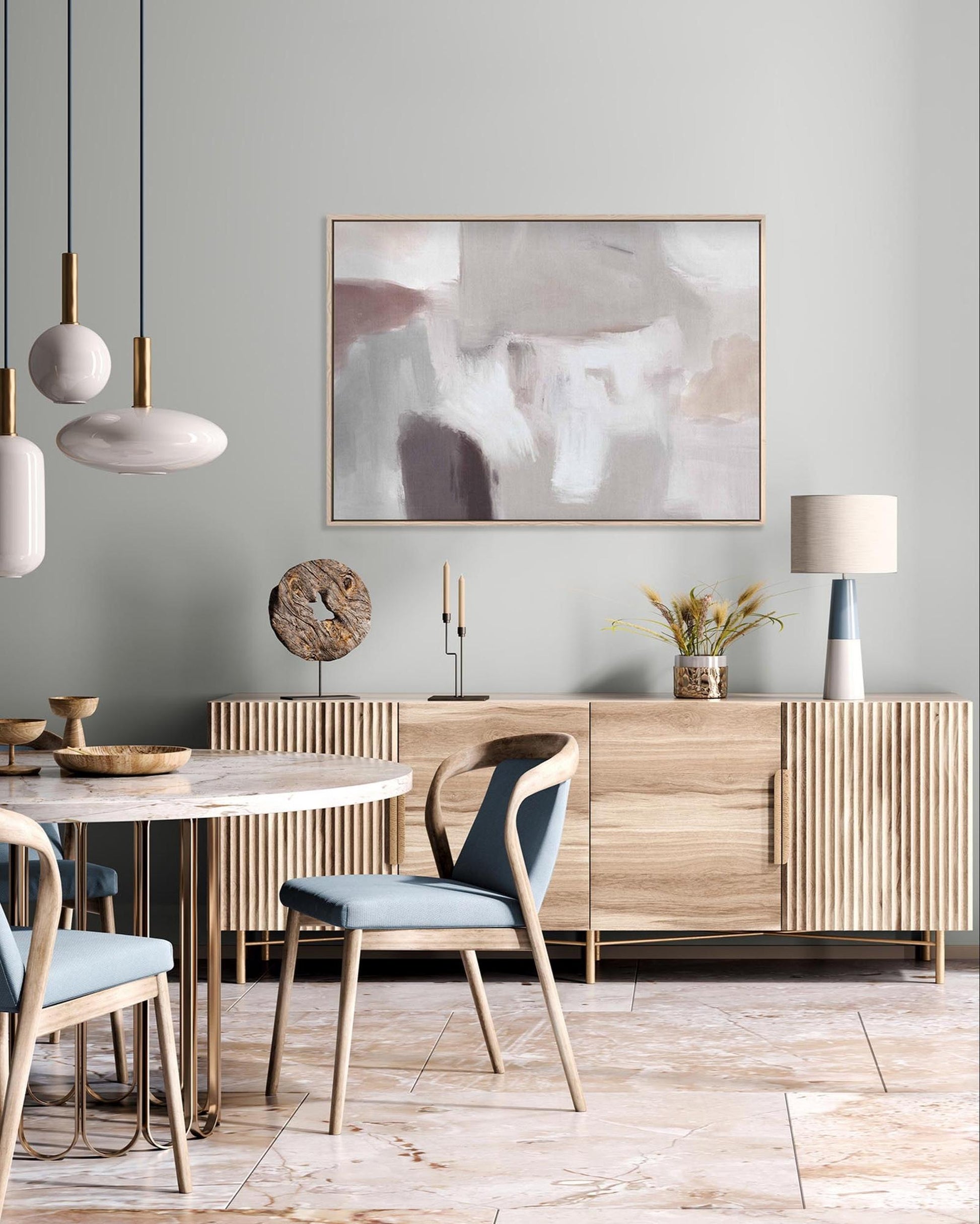 Modern dining room with wooden furniture, abstract art, and pendant lights.