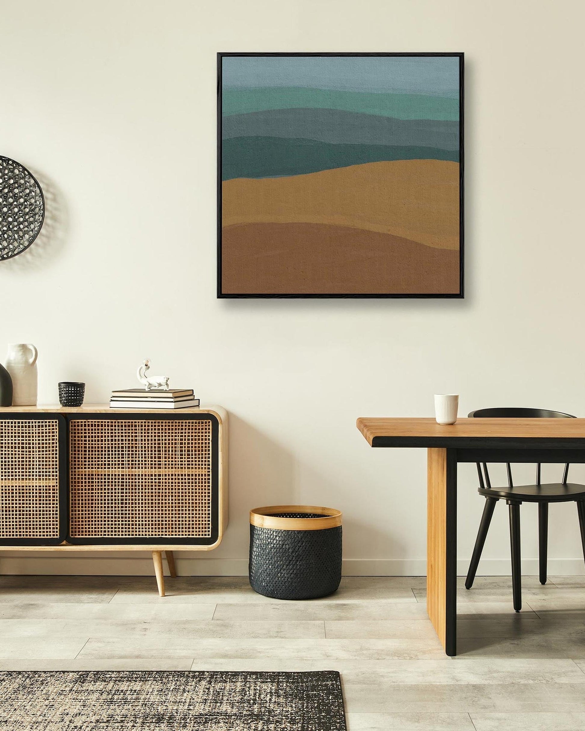 Modern interior with a wooden sideboard, abstract wall art, and a dining table.