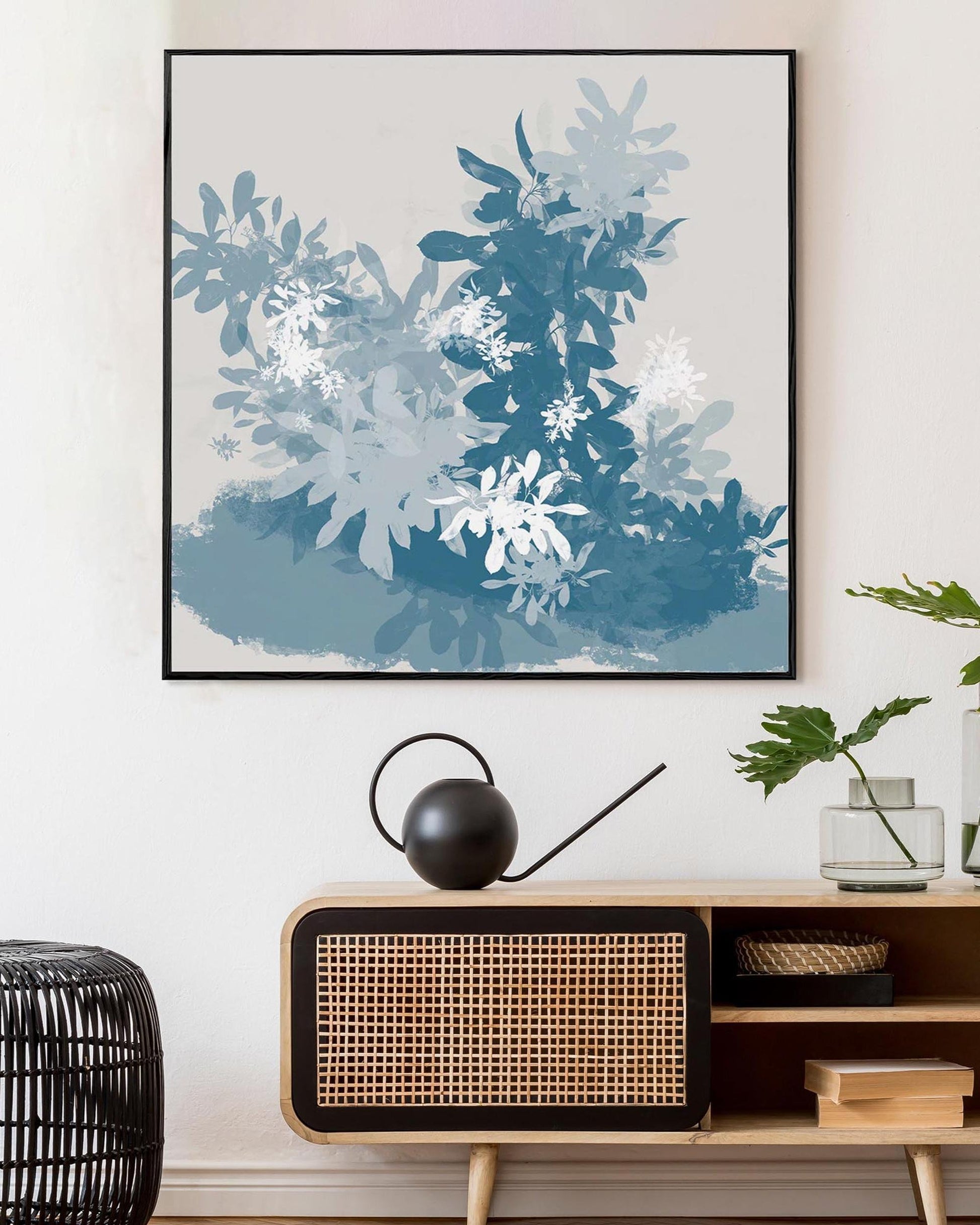 Framed abstract art above a wooden console table with decorative items.
