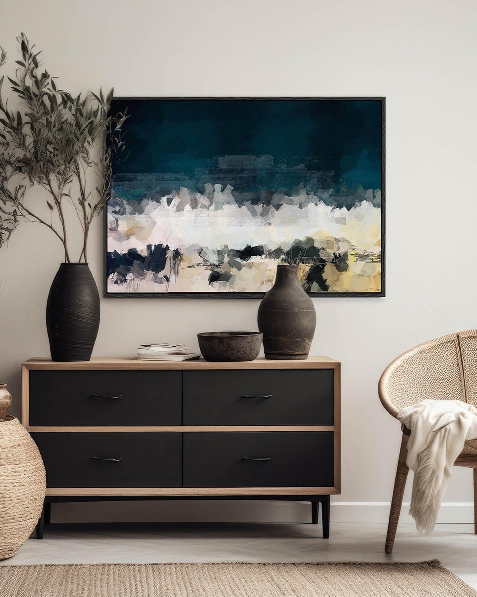 Modern interior with a dresser, abstract painting, and decorative items.