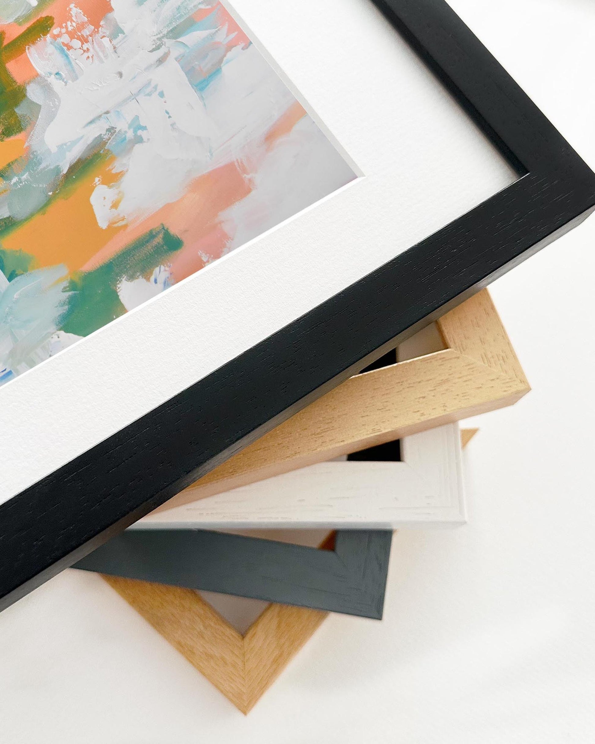 Stack of variously colored picture frames on a white background