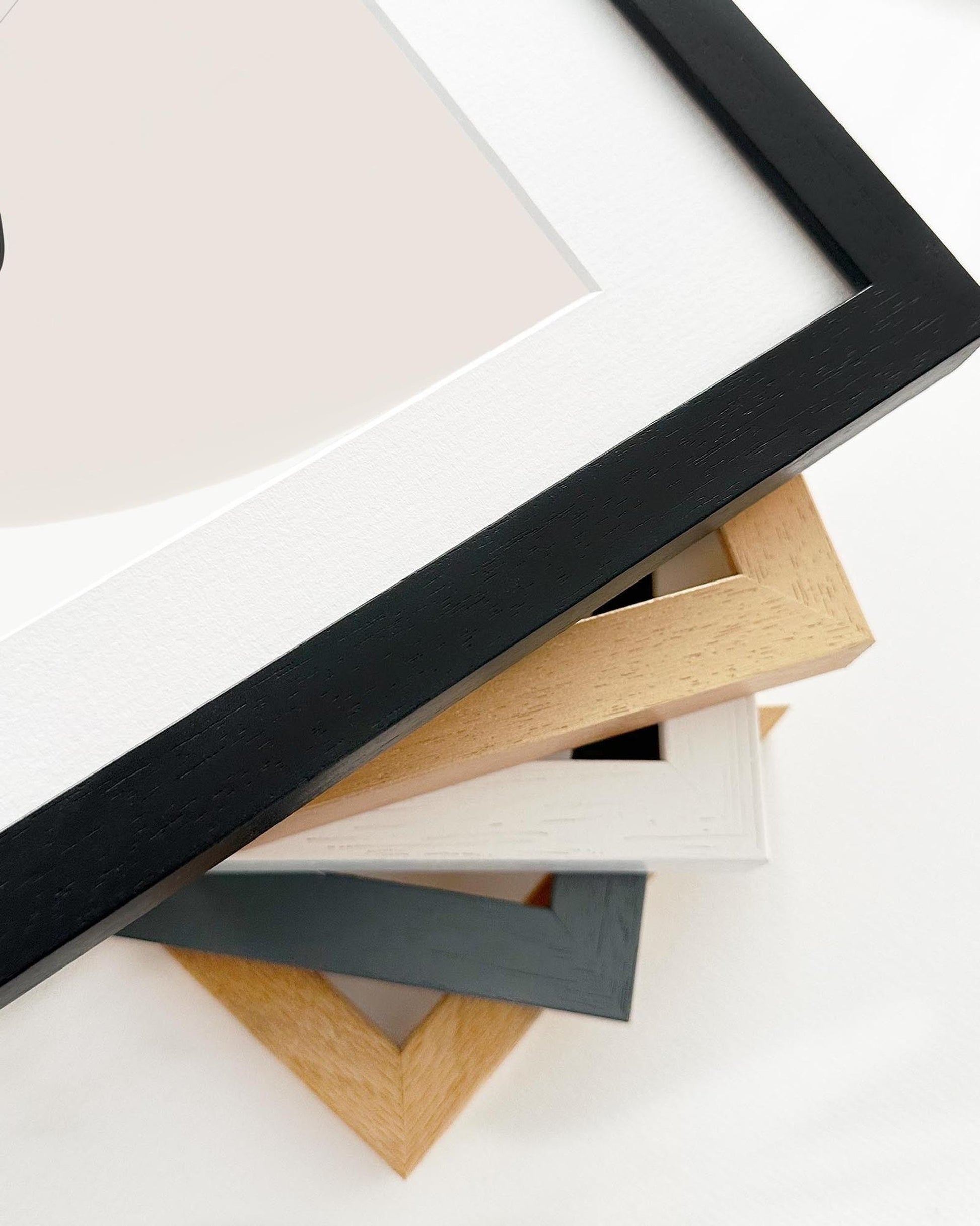 Collection of various wooden picture frames on a white background