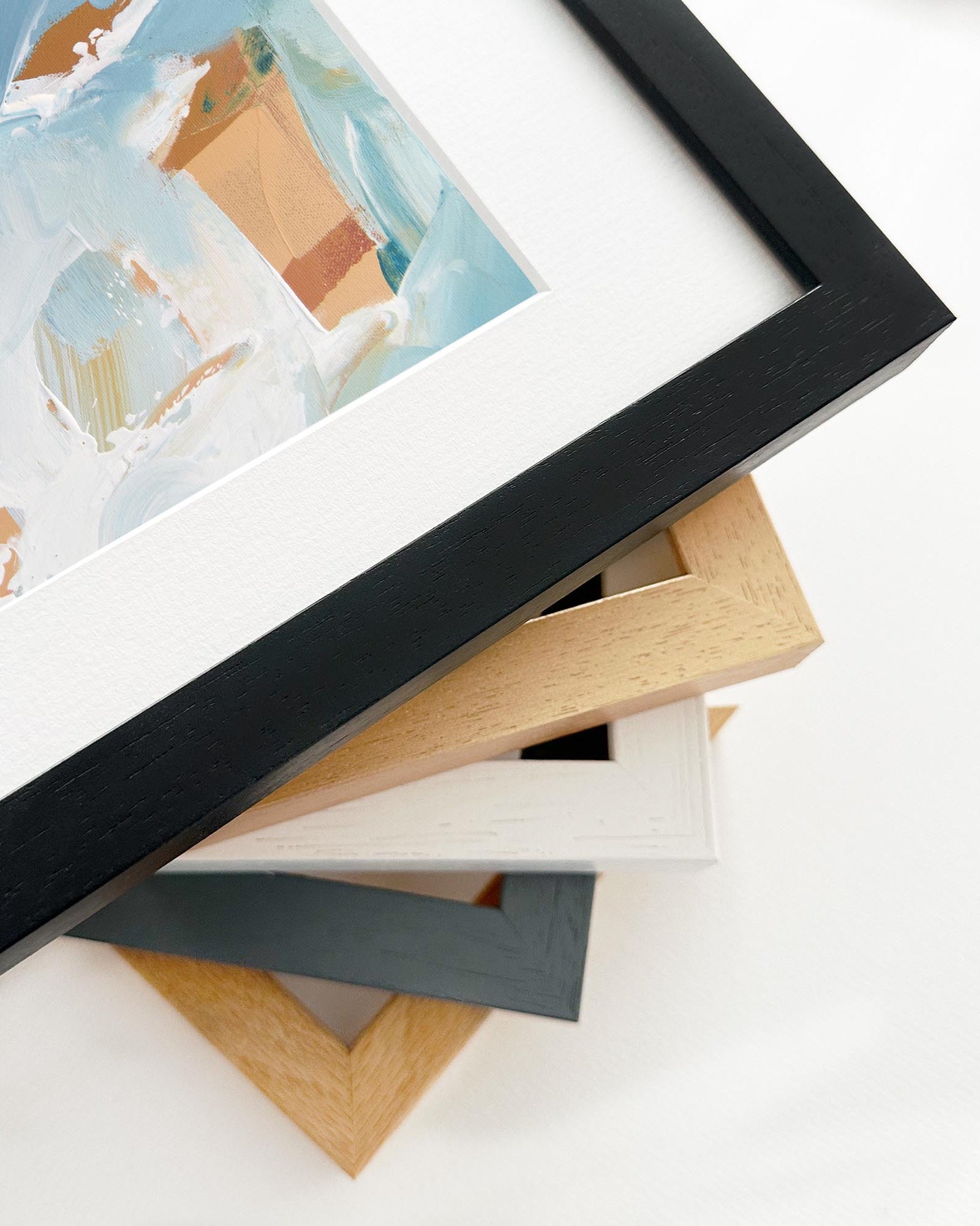 Stack of variously colored picture frames on a white background