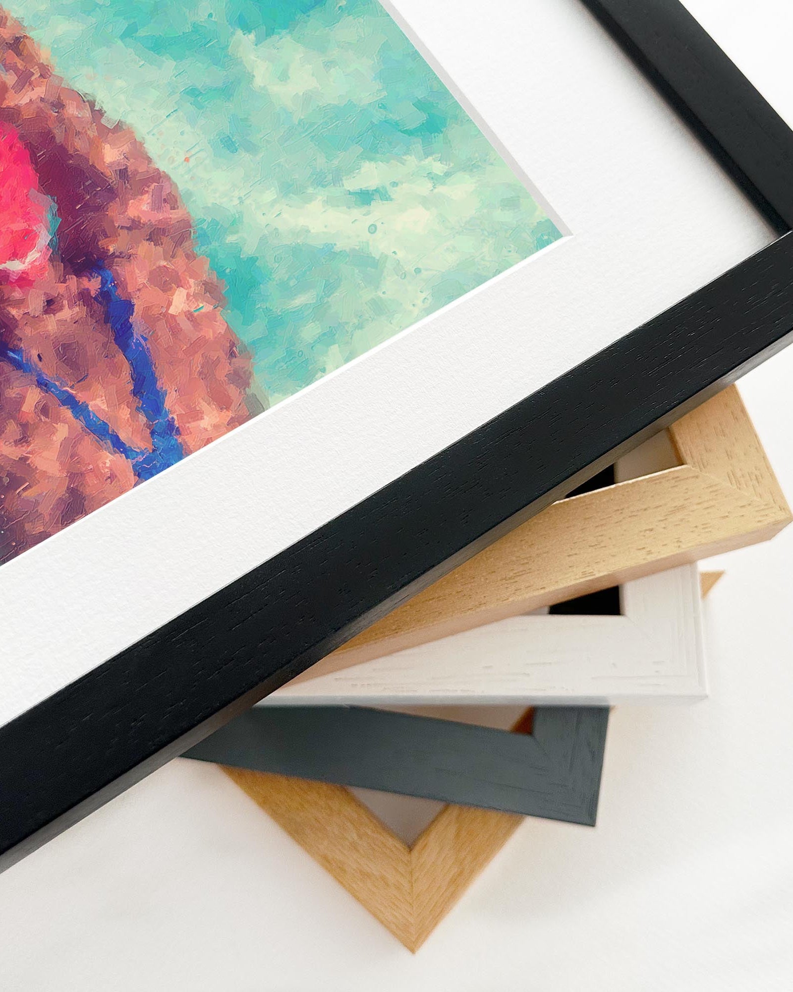 Stack of variously colored picture frames on a white surface