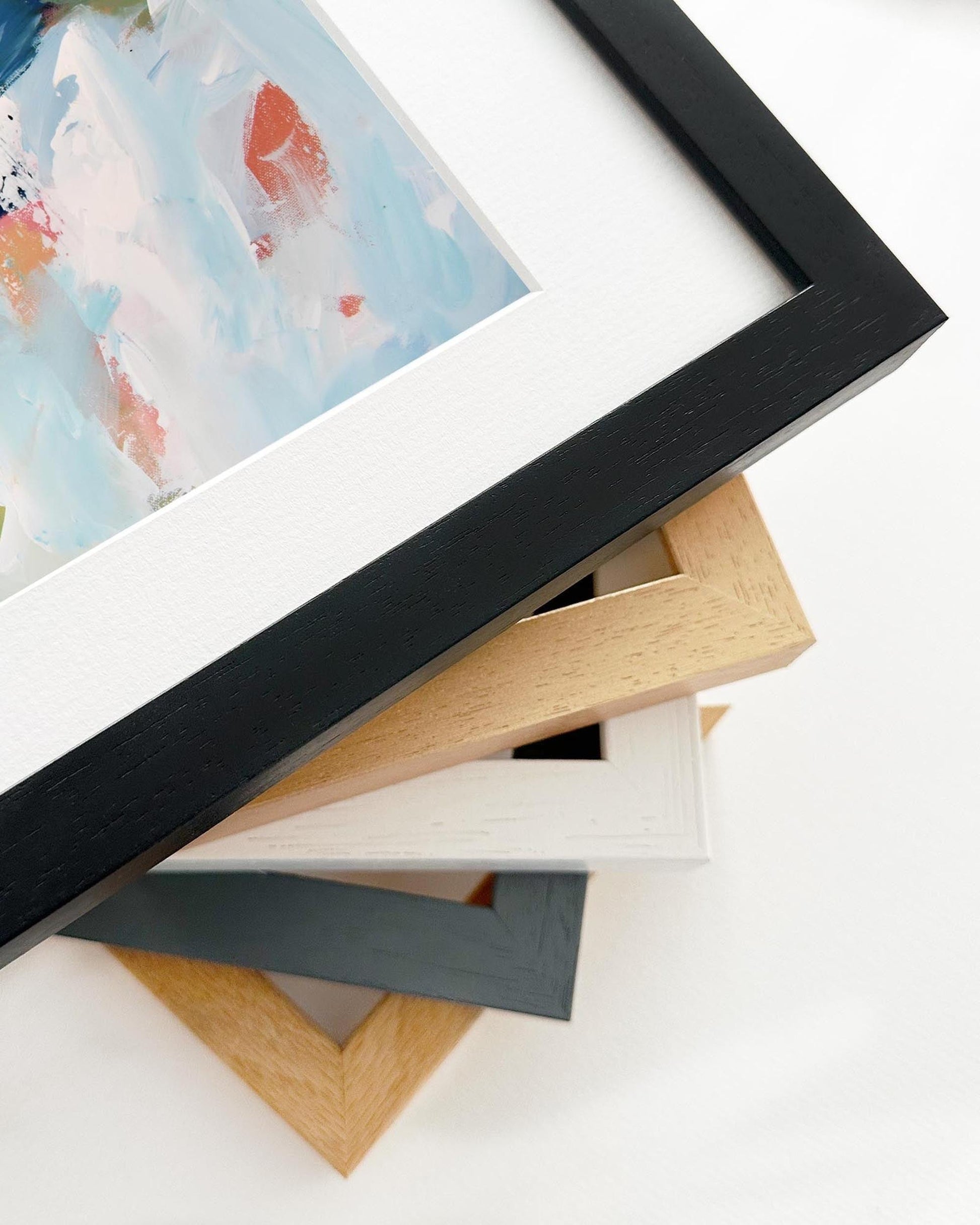 Stack of various photo frames on a white surface