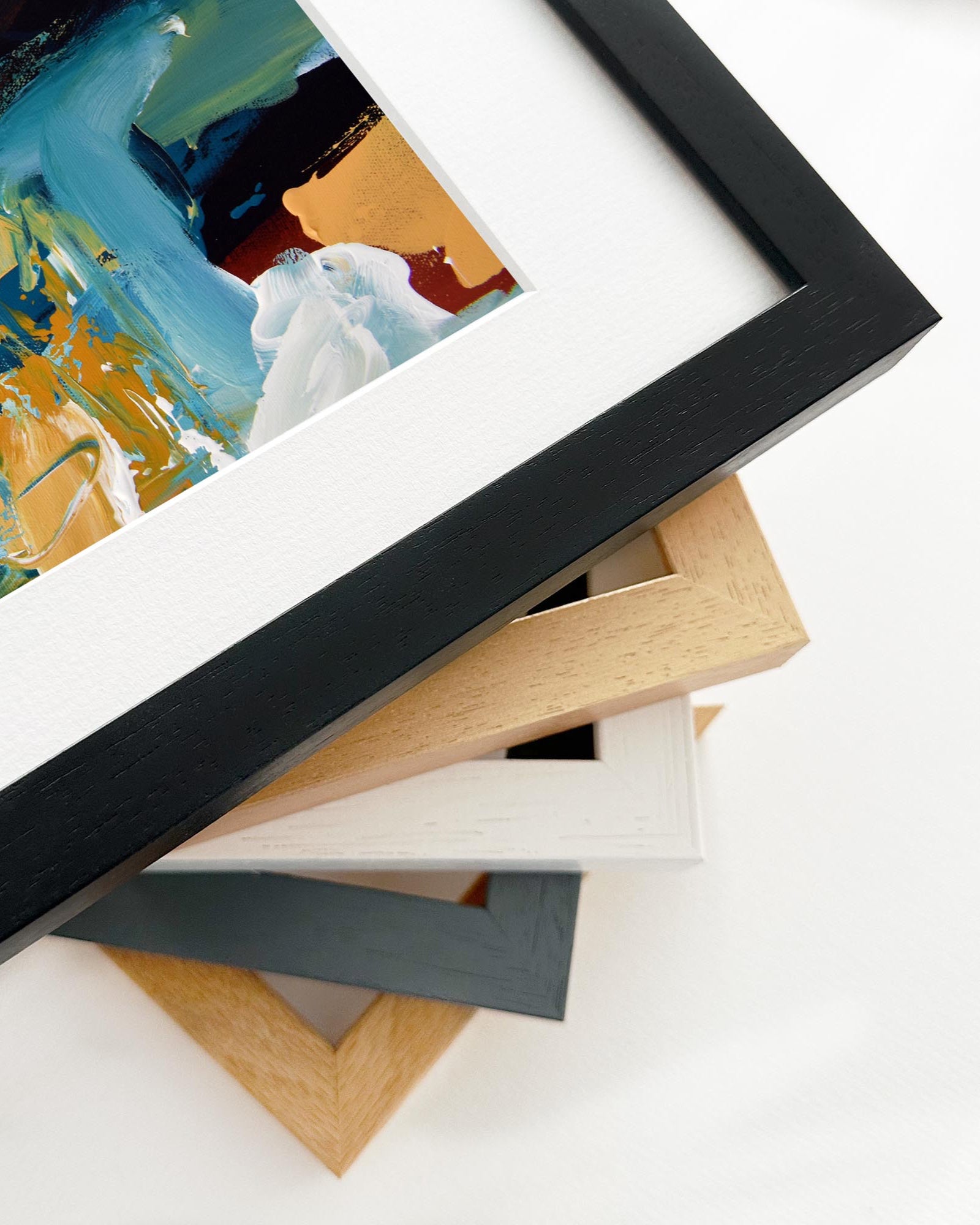 Stack of variously colored picture frames on a white background