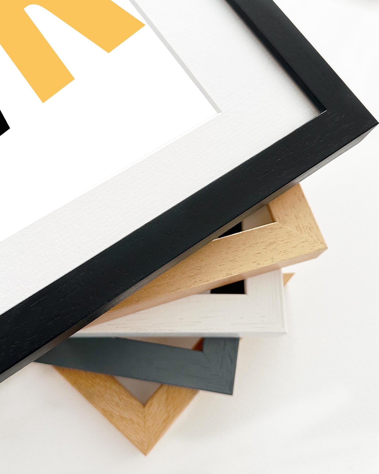 Stack of variously colored picture frames on a white background