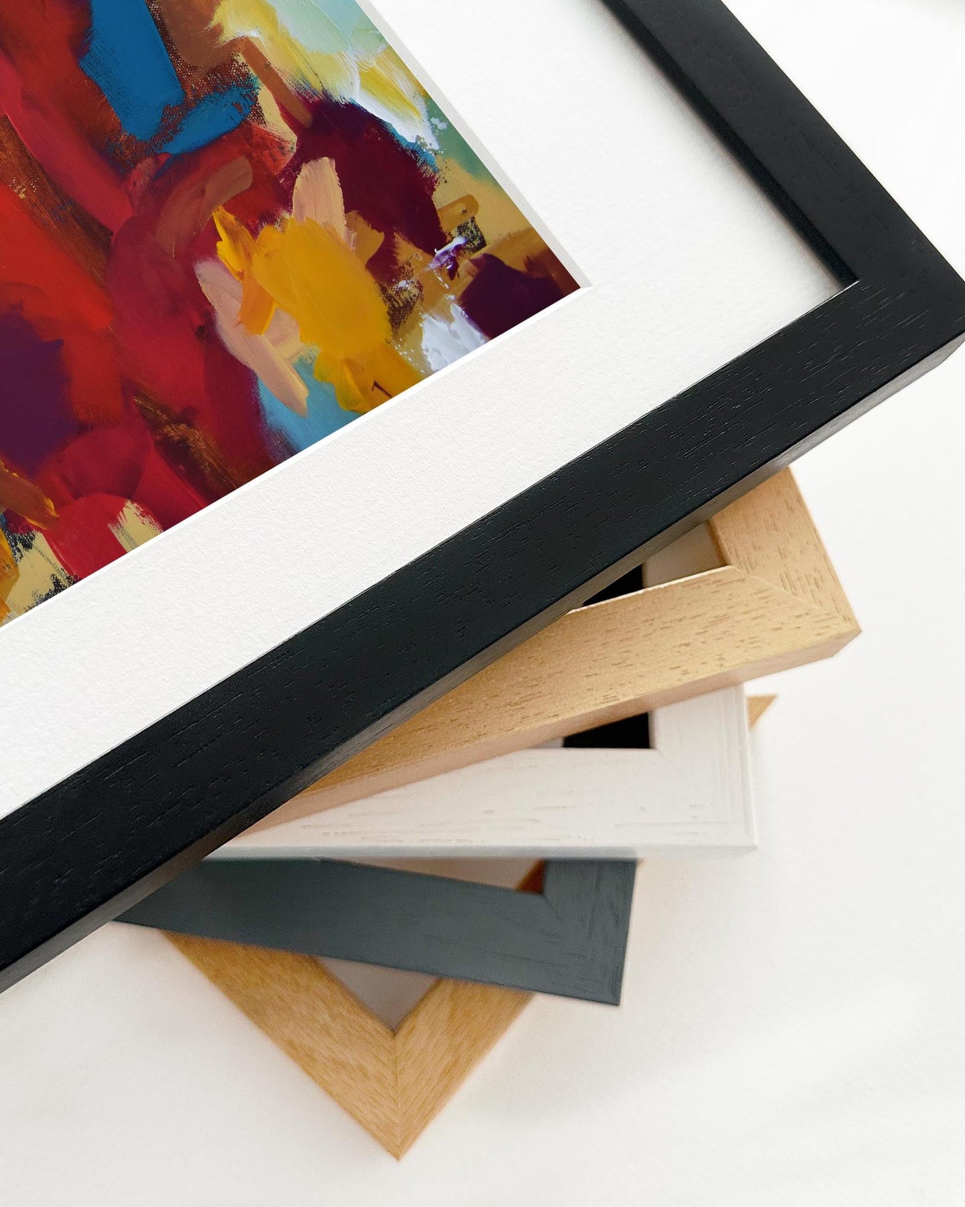 Collection of variously framed artworks on a white background