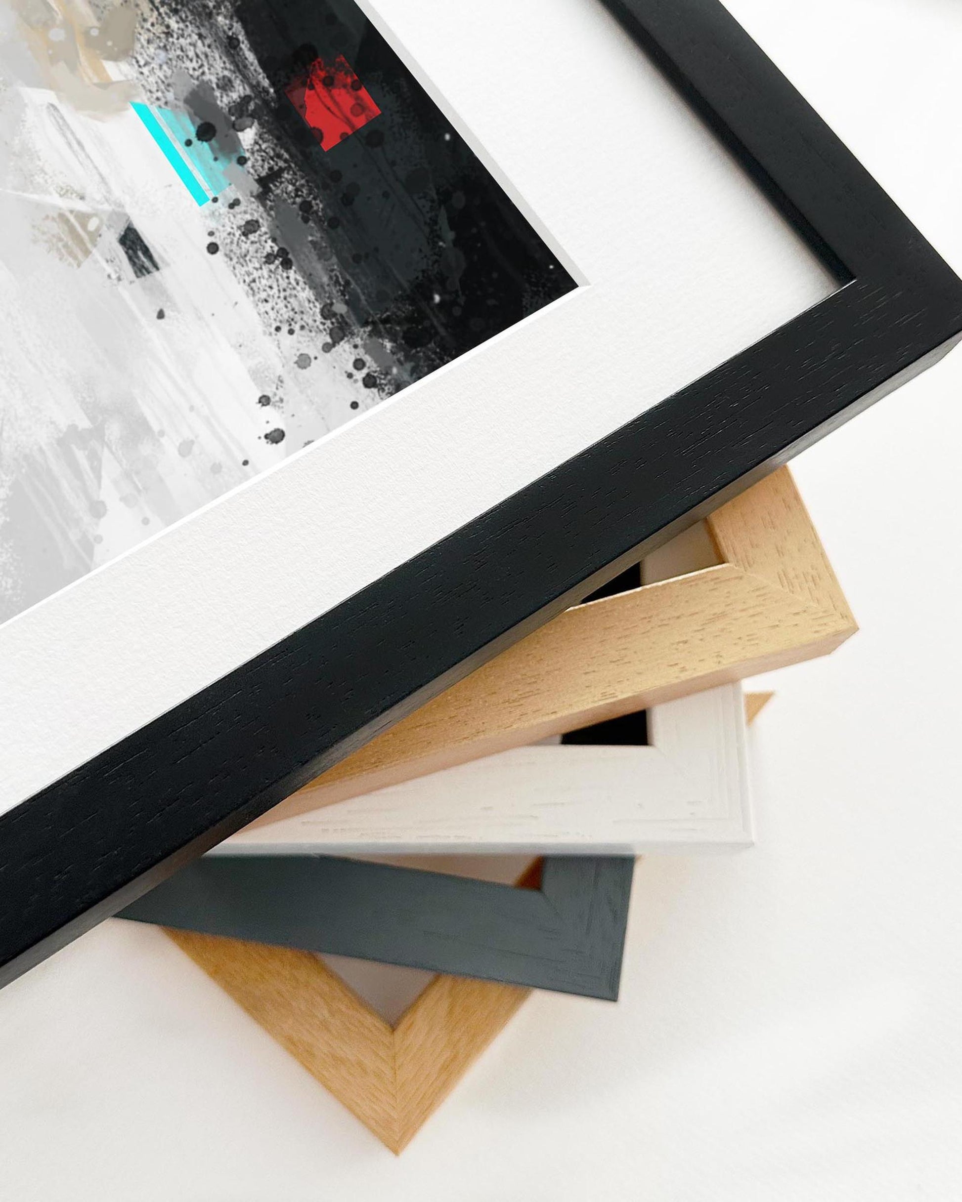 Stack of variously shaped and colored picture frames on a white background
