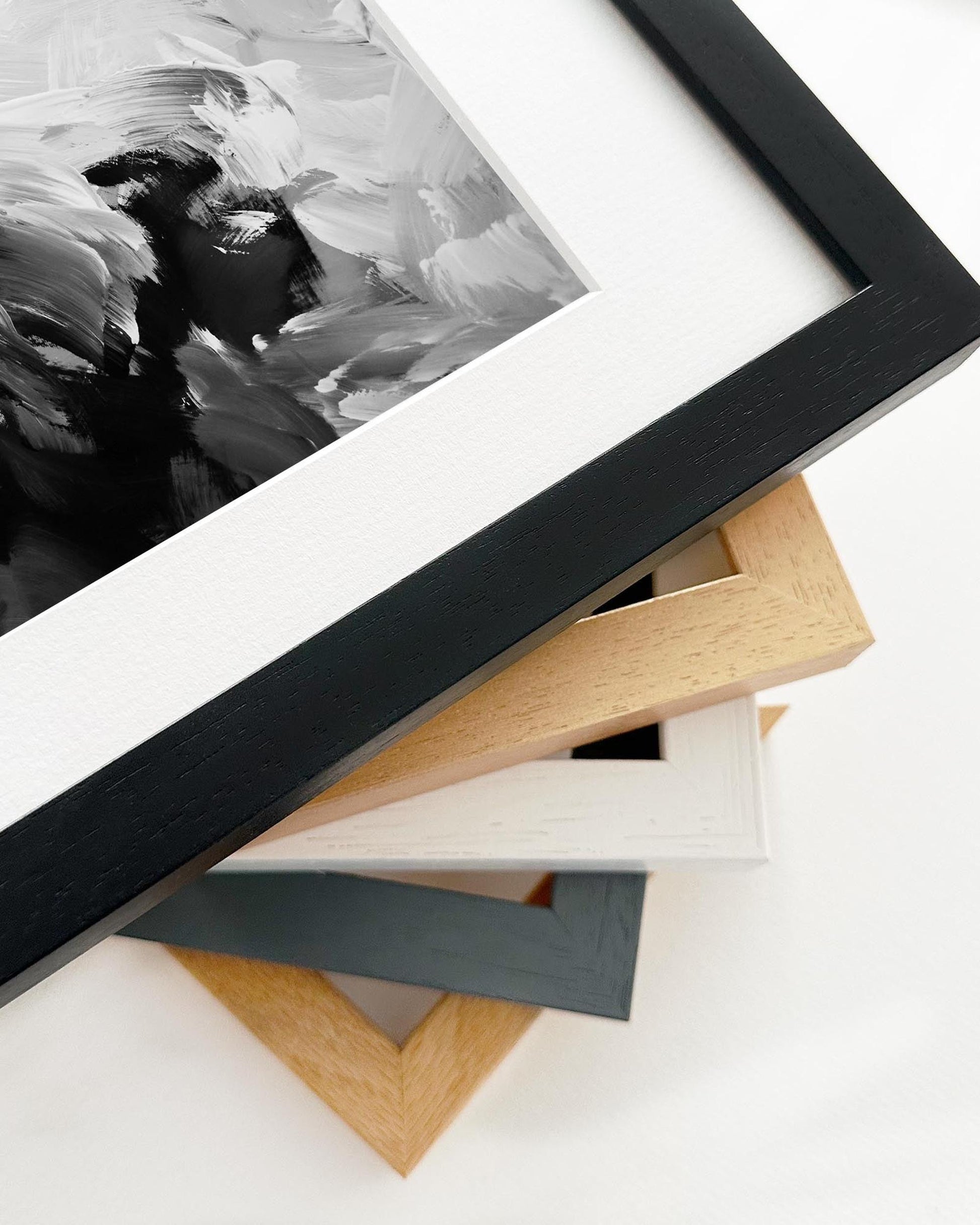 Close-up of various picture frames on a white surface