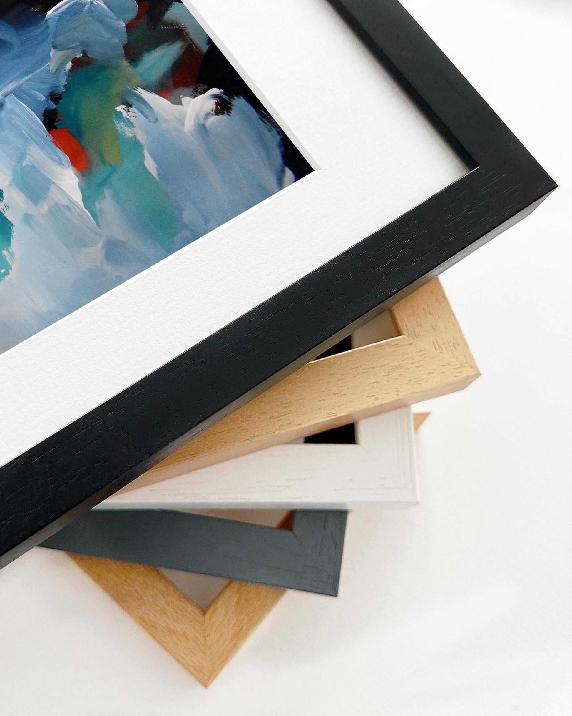 Stack of variously colored picture frames on a white background