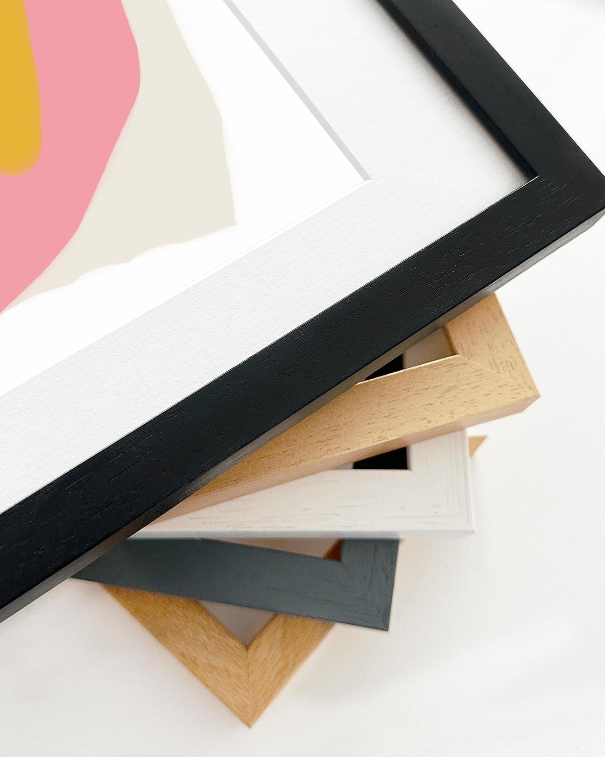 Collection of variously colored and shaped picture frames on a white background