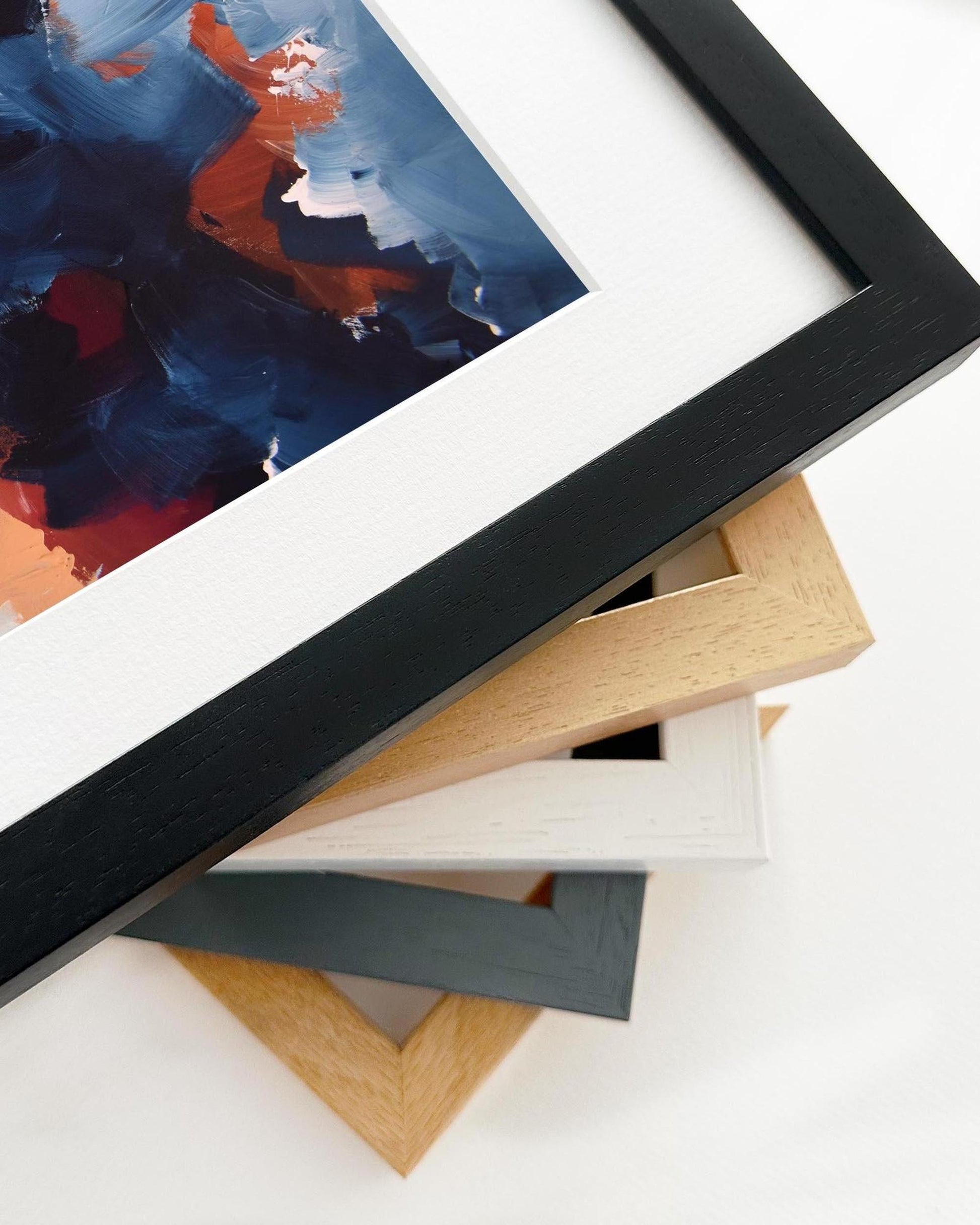 Collection of variously colored picture frames on a white surface