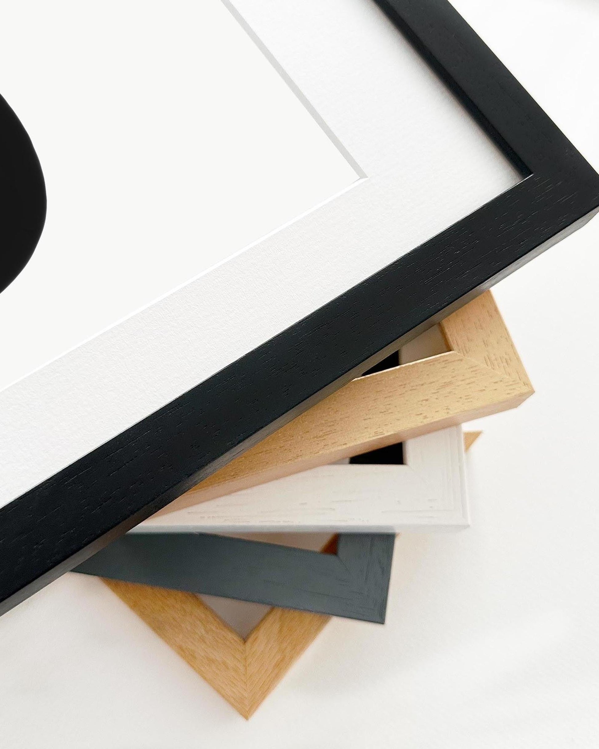 Collection of various wooden picture frames on a white background
