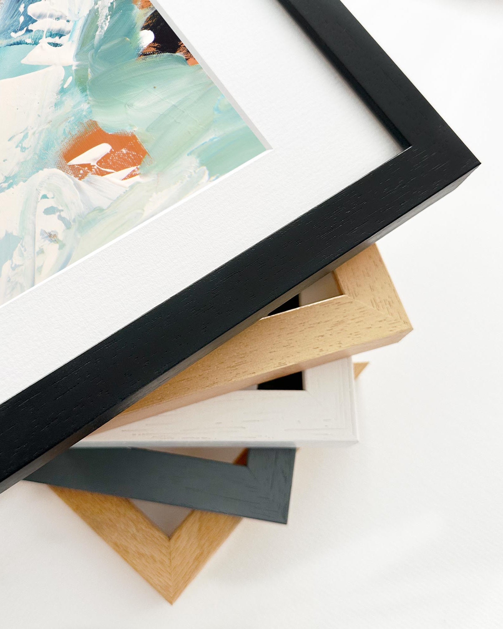 Stack of various photo frames on a white surface
