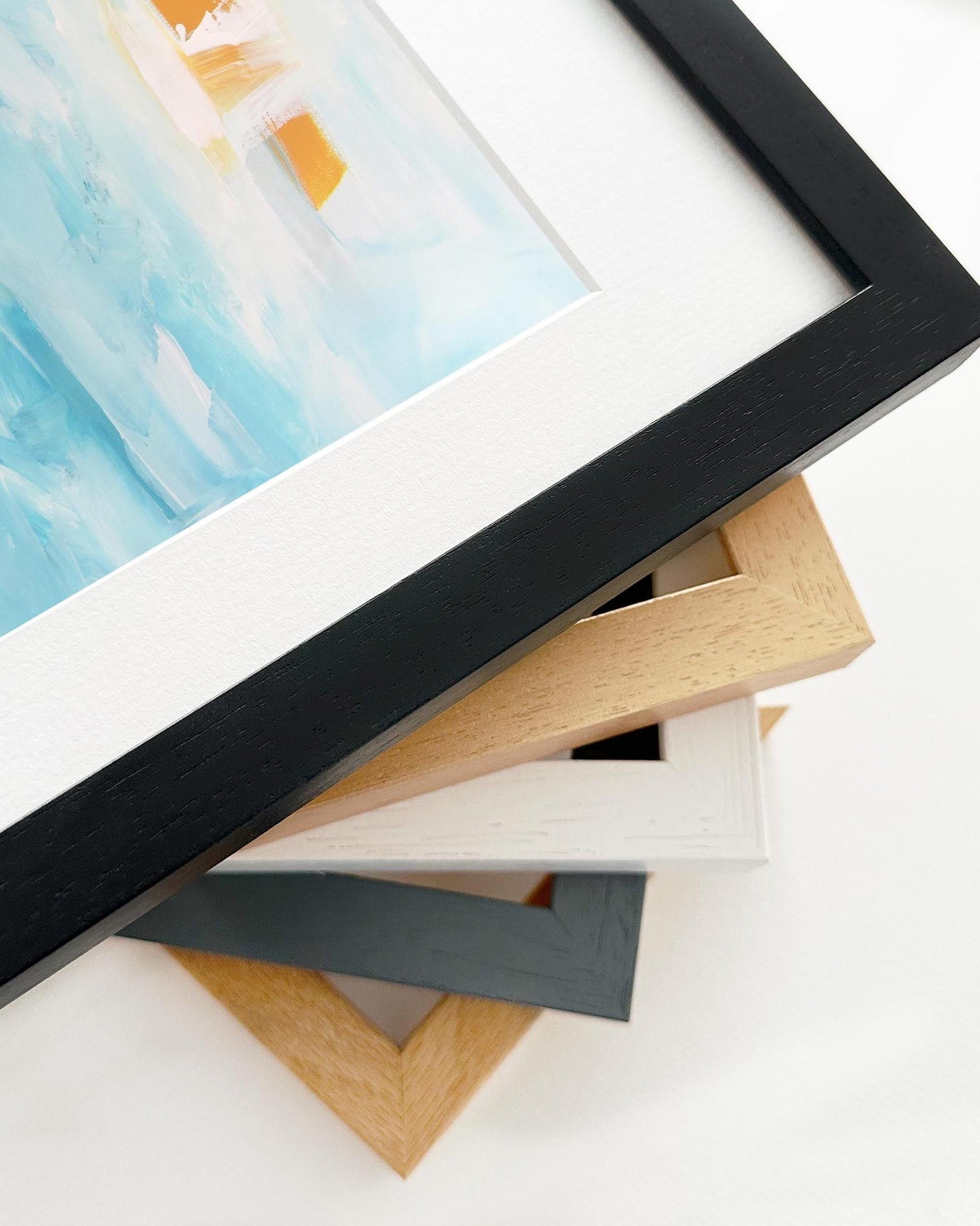 Collection of variously colored picture frames on a white surface