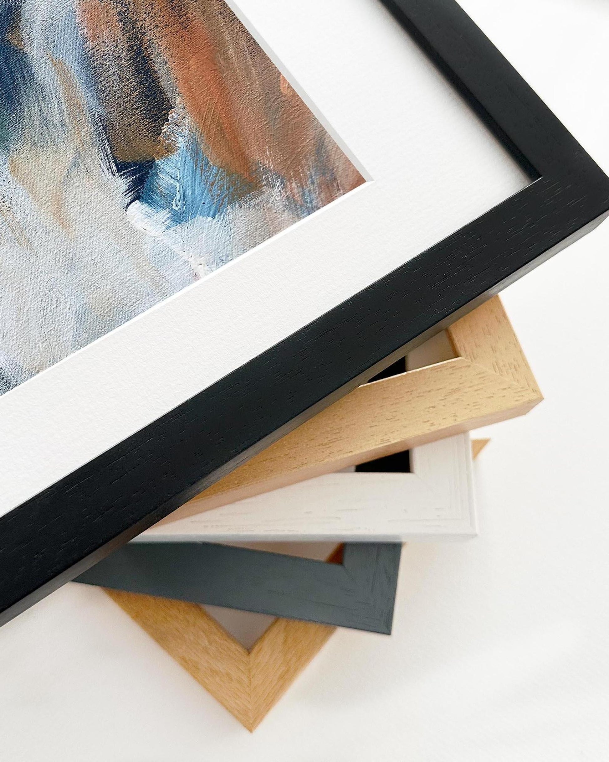Stack of various picture frames on a white background