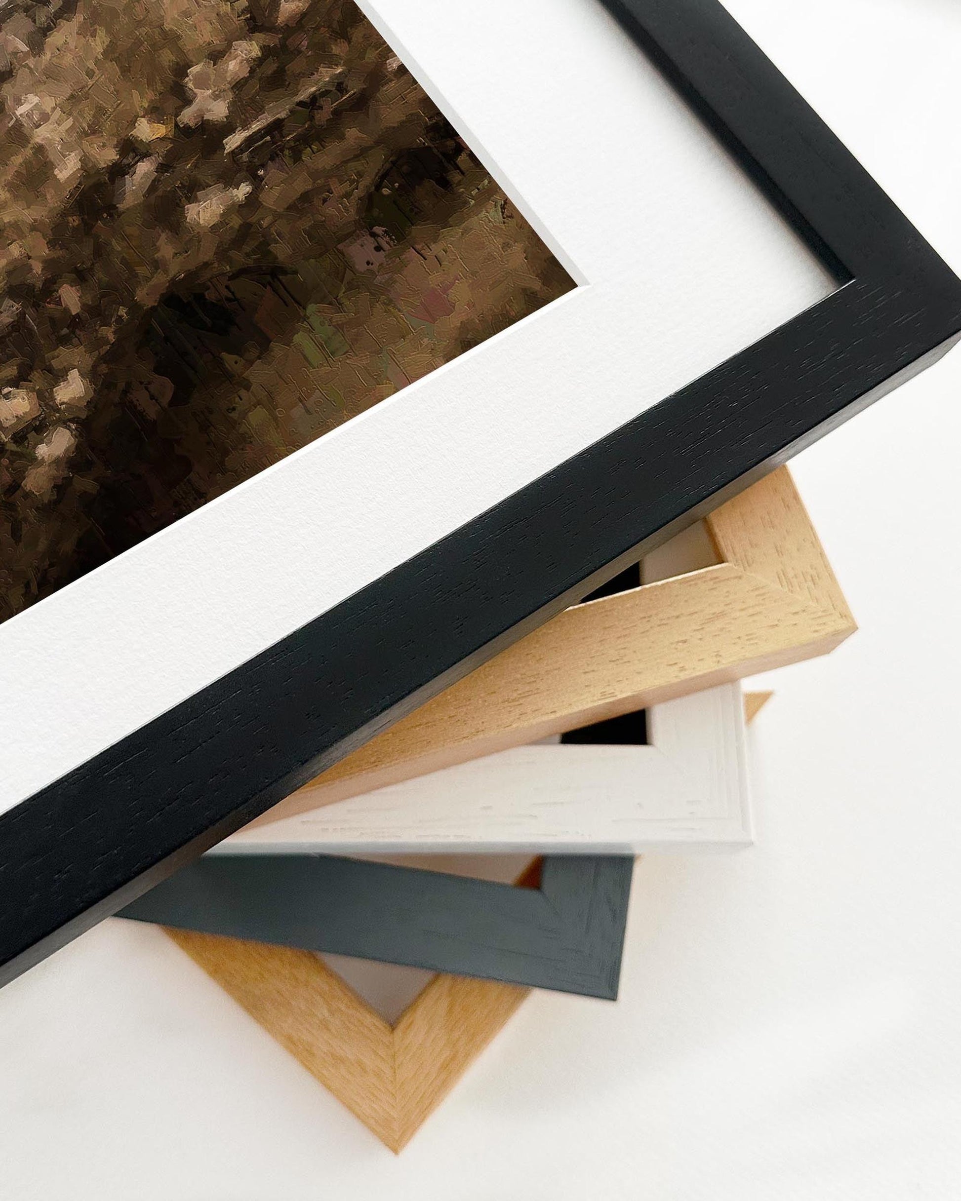 Stack of various picture frames on a white surface