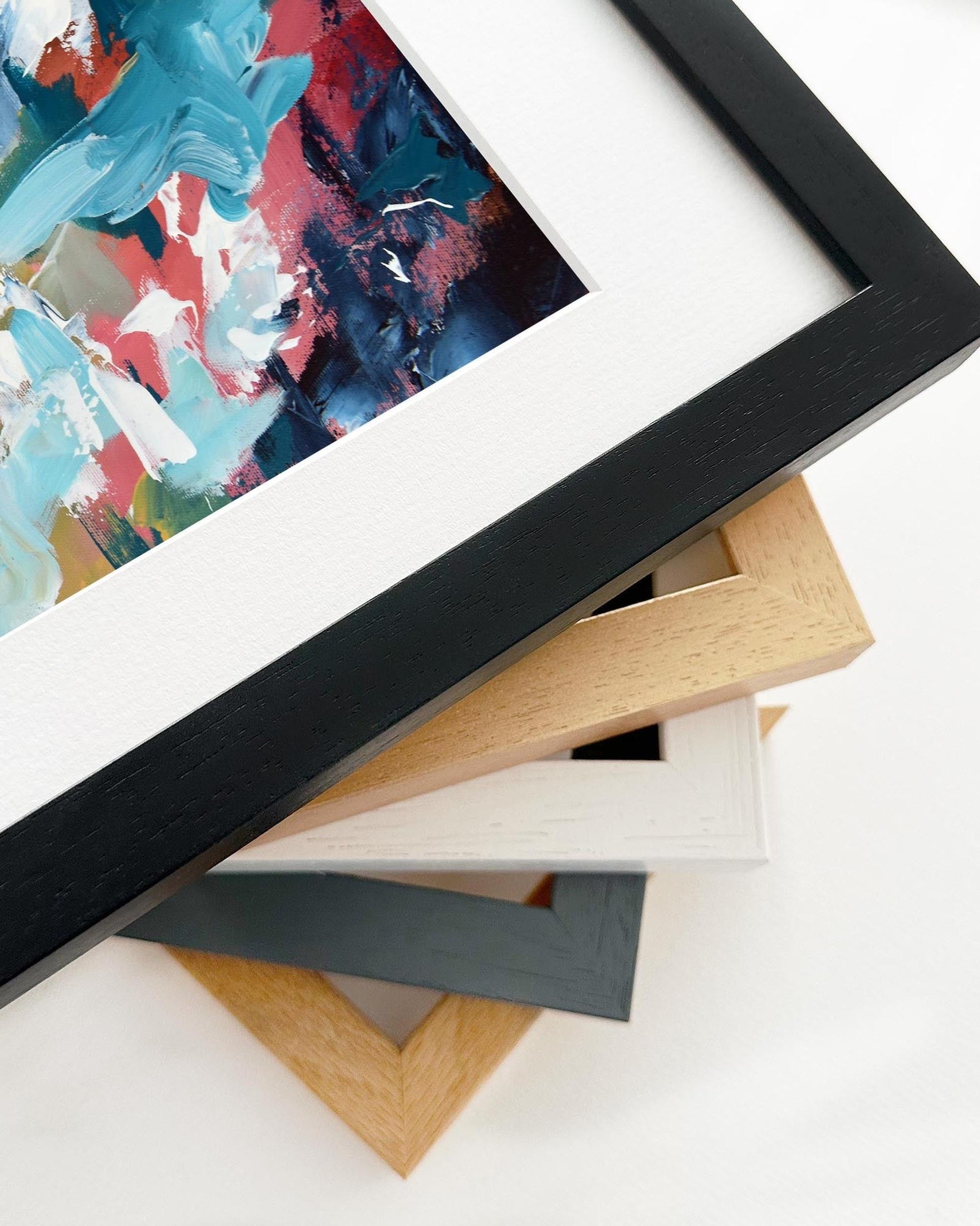 Framed abstract artwork with a stack of variously colored frames on a white background