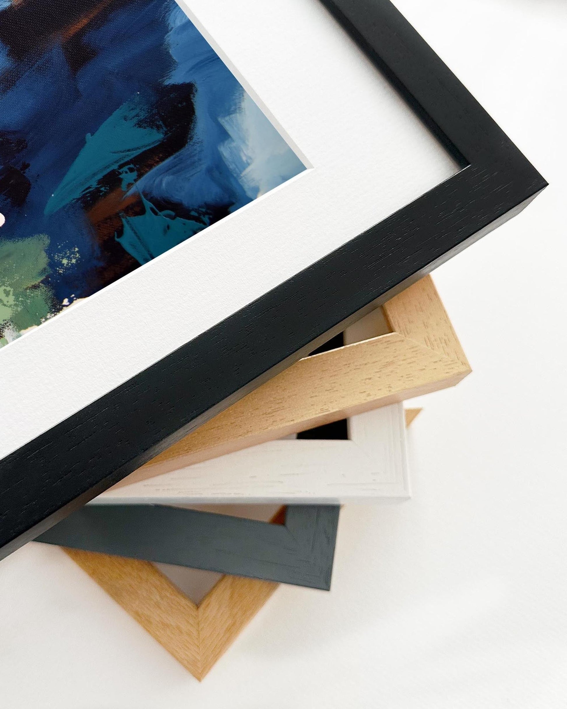 Stack of various photo frames on a white surface
