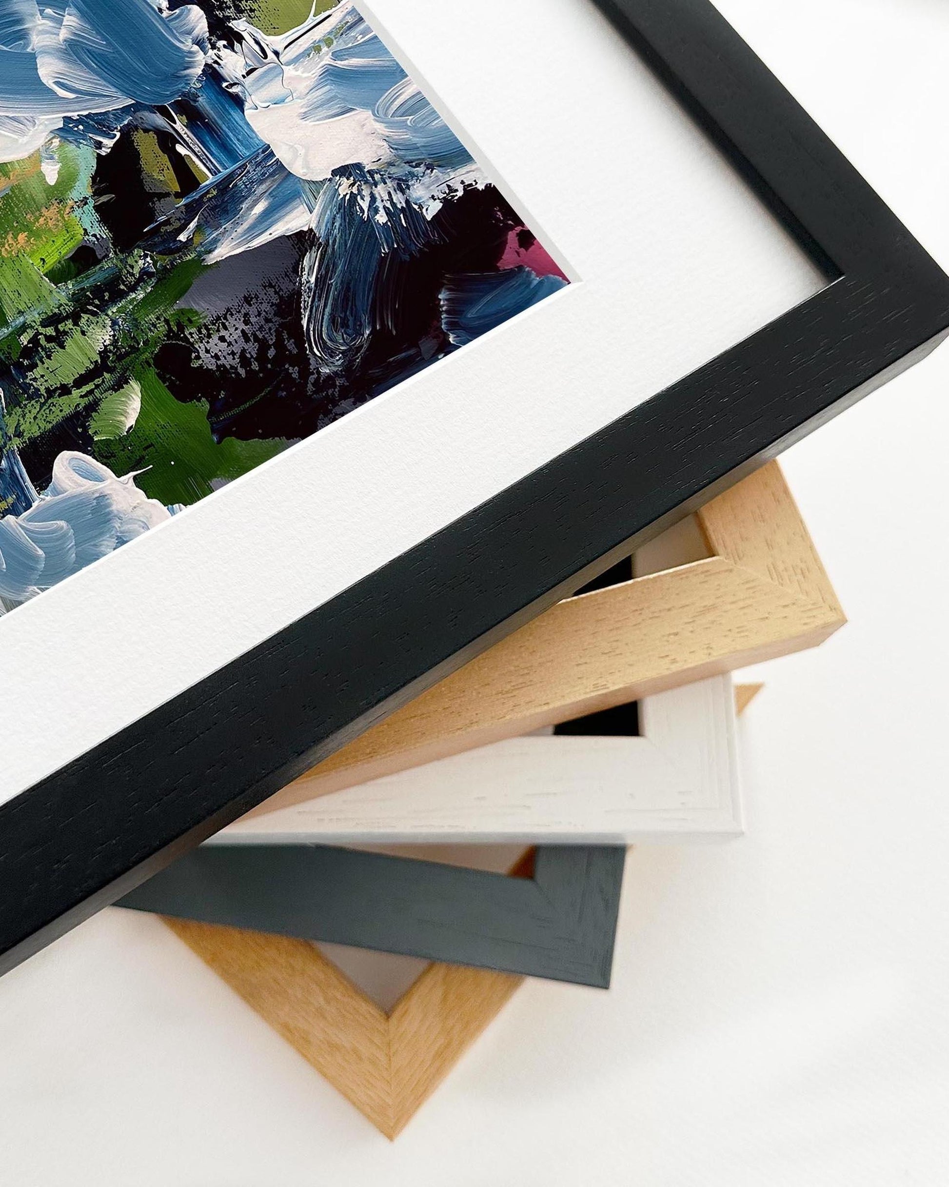 Stack of various photo frames on a white surface