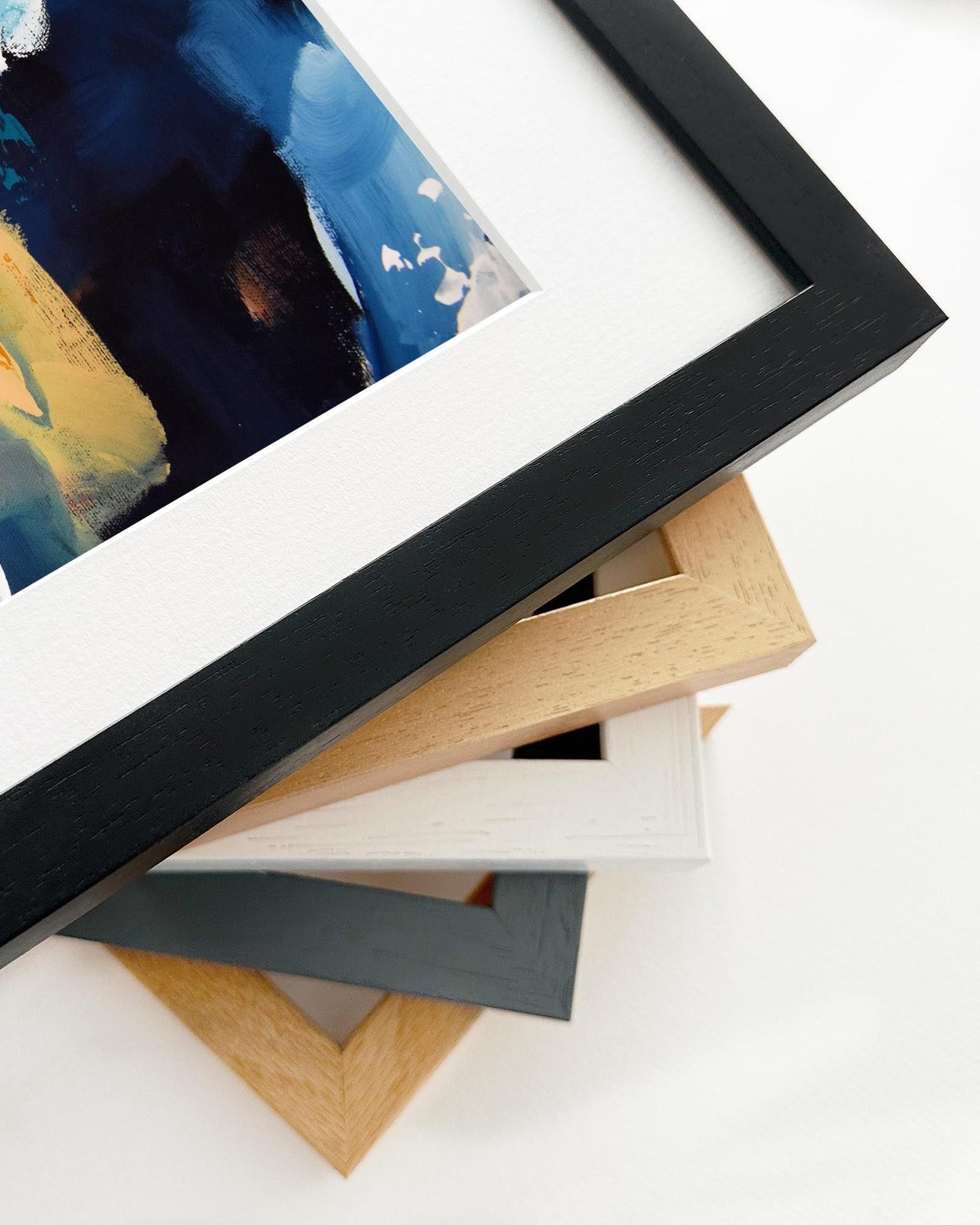 Stack of various photo frames on a white surface